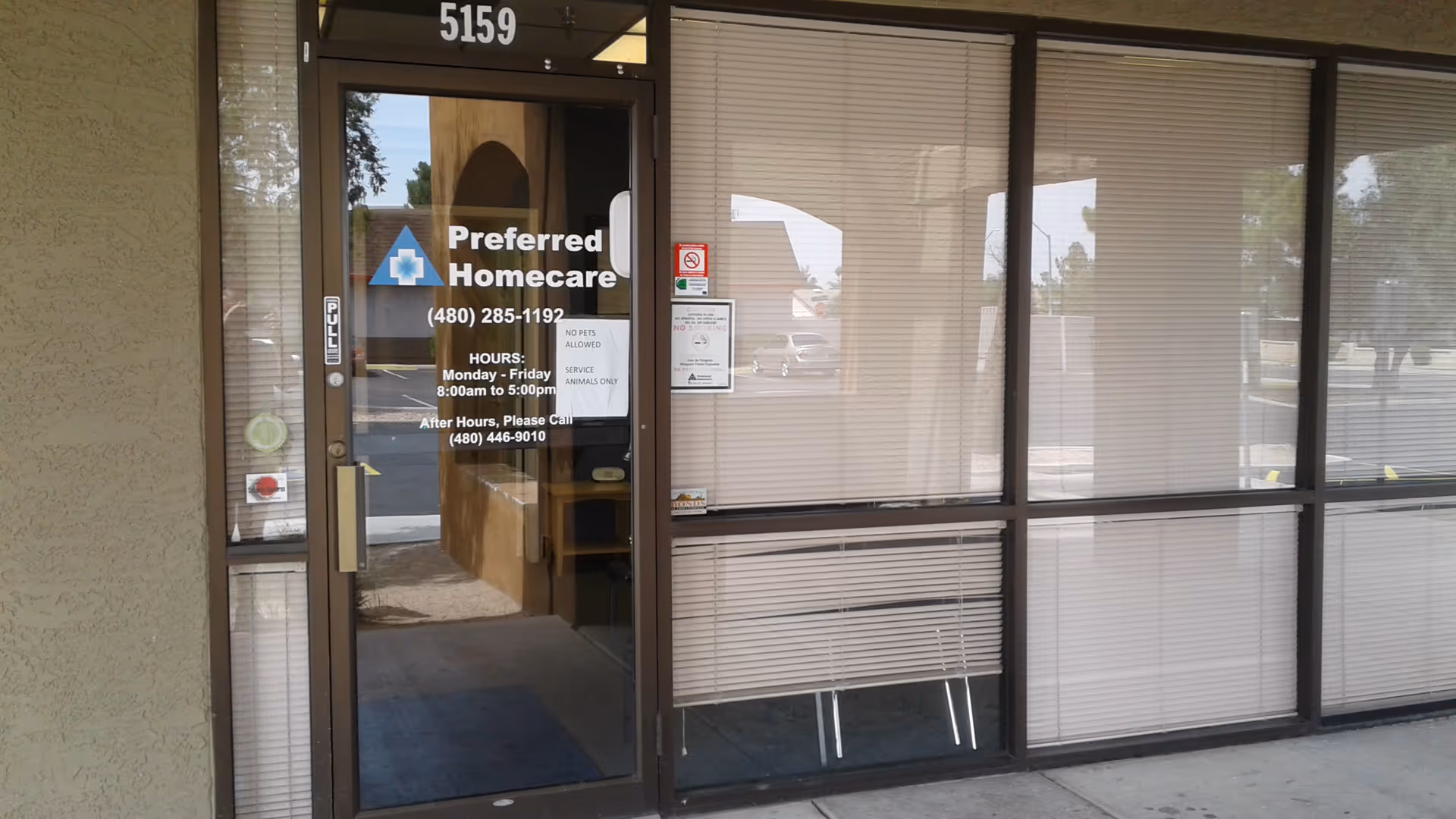 Glass-front entrance for Preferred Homecare Glendale with blinds and sidewalk.