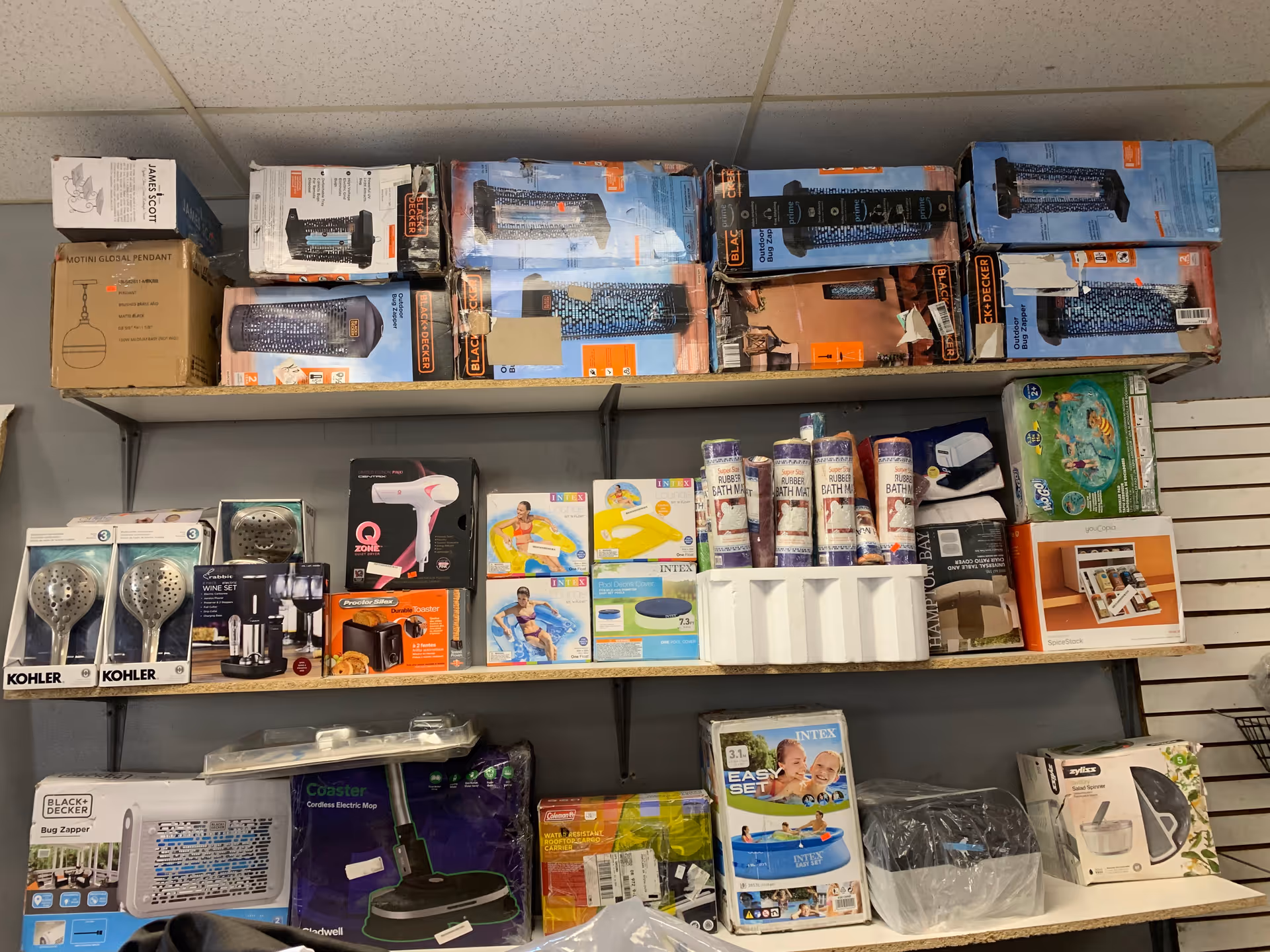 Shelves stocked with boxed household and bath products in a store-like setting.