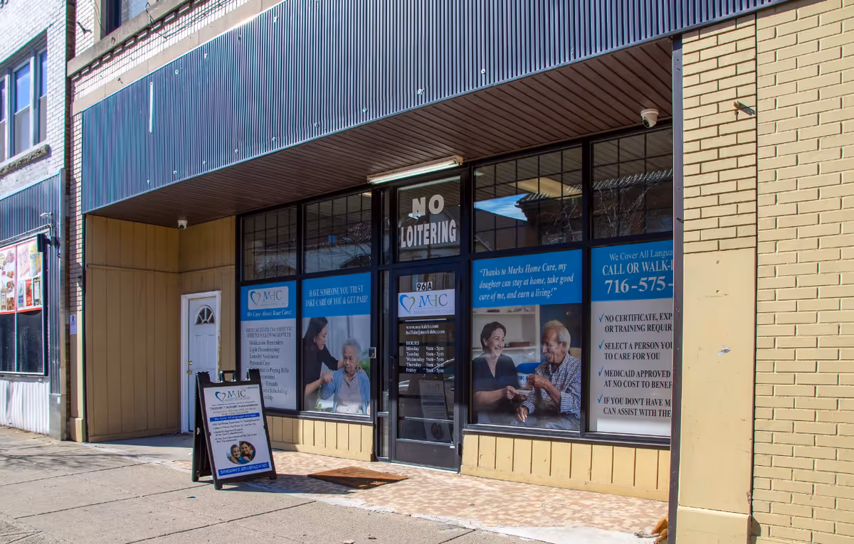 Front of Marks Home Care Agency storefront with large windows and posters.