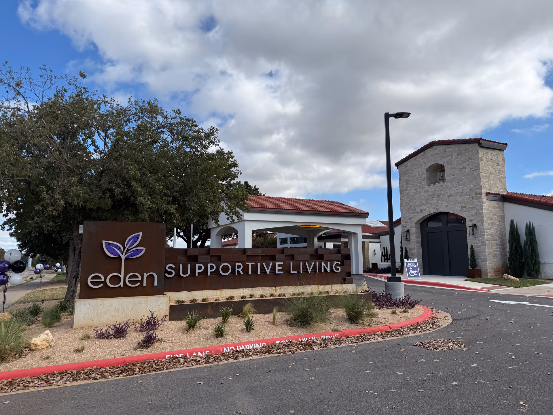 Exterior view of The Wesleyan at Scenic entrance with eden Supportive Living sign