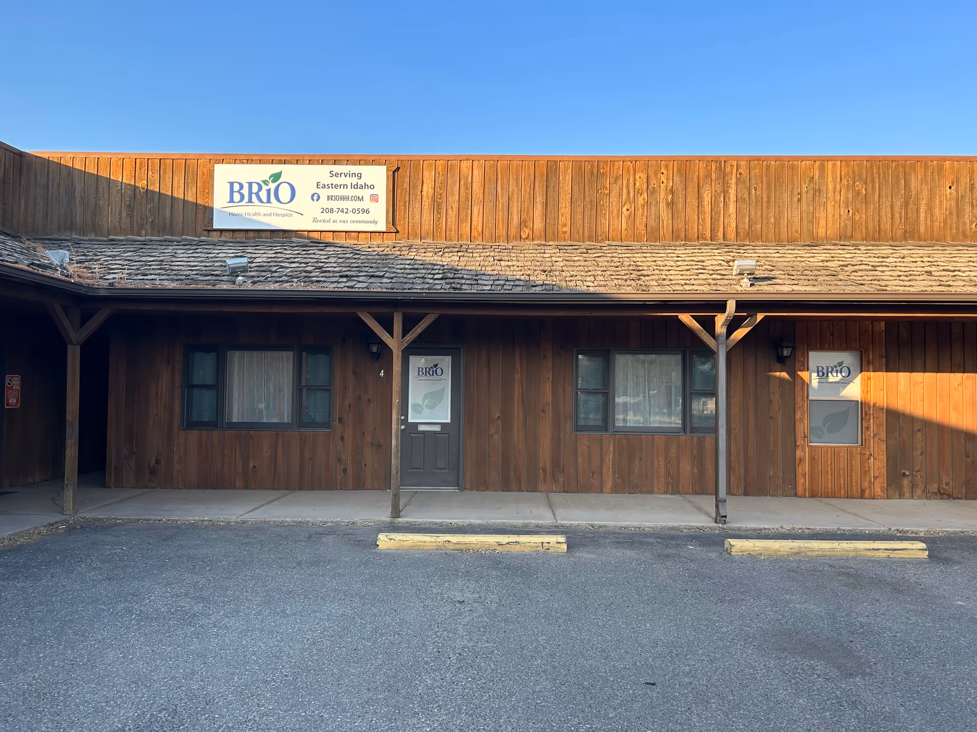 Wooden front of BRiO Home Health and Hospice building with sign