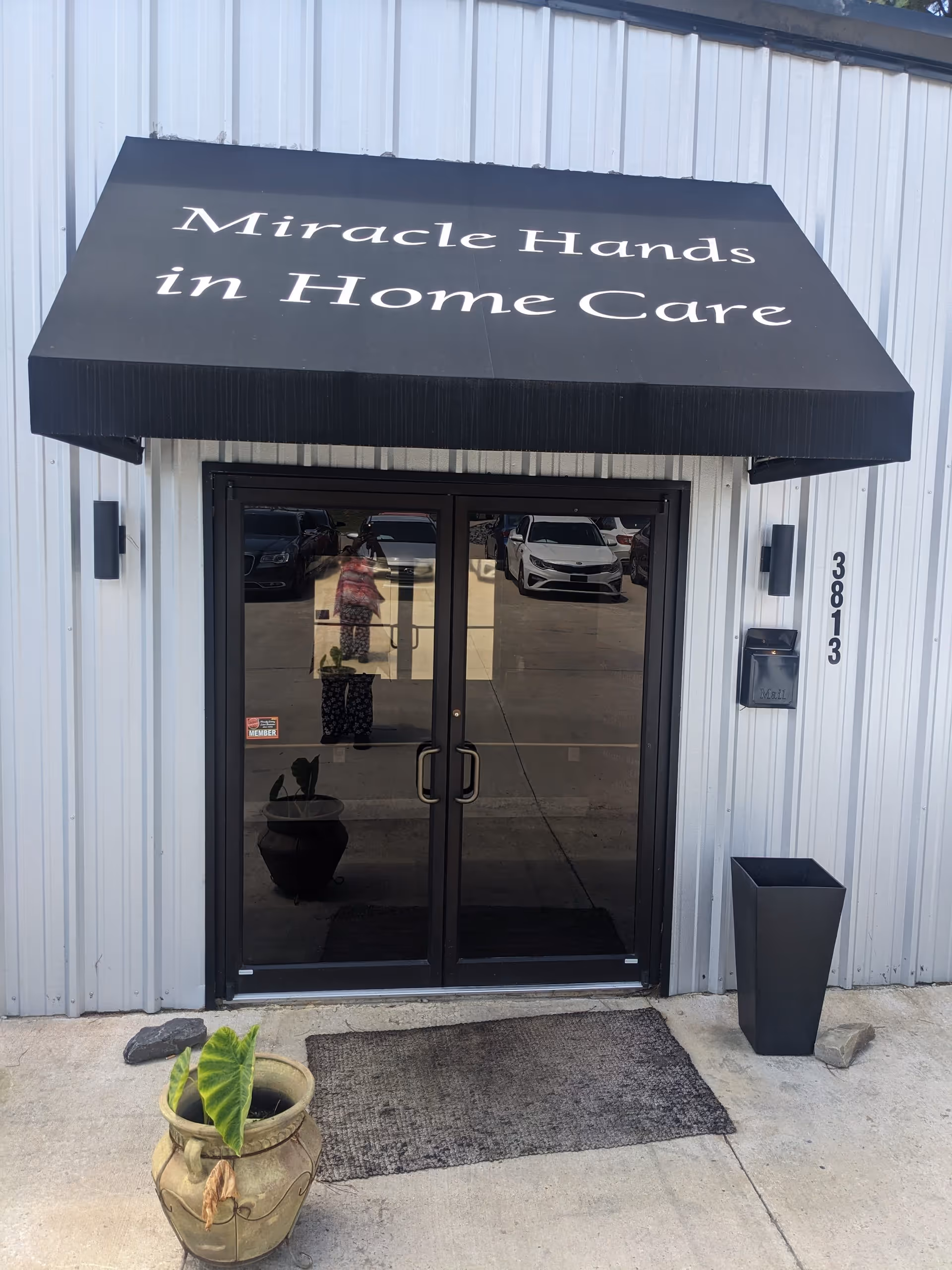 Exterior view of Miracle Hands in Home Care entrance with glass doors and signage.