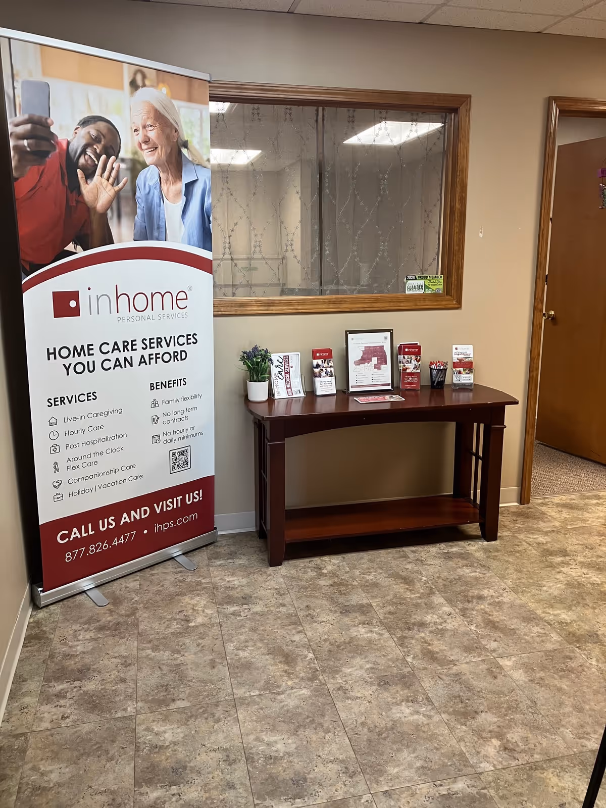 Interior lobby with an In Home Personal Services banner beside a brochure table.
