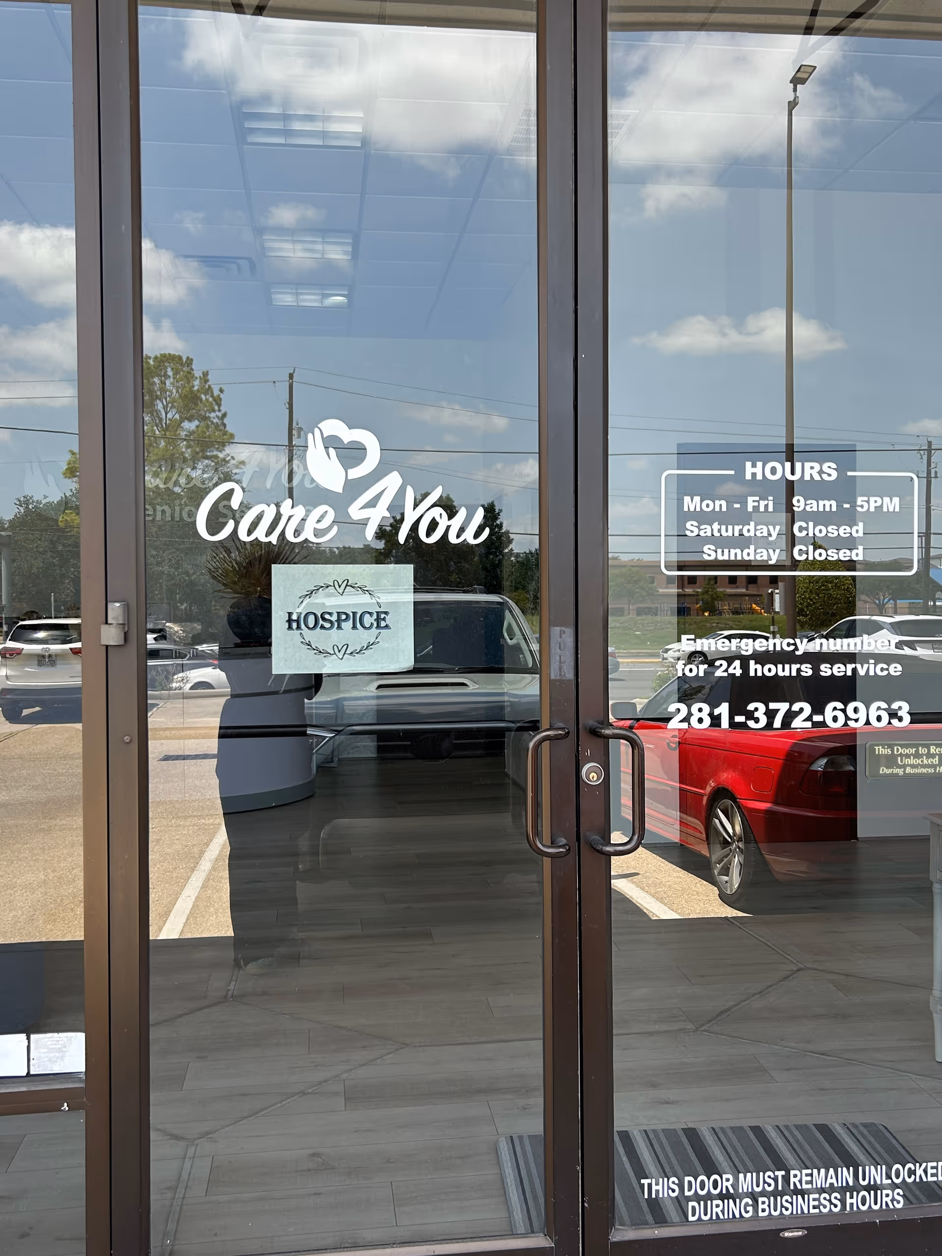 Glass entrance door for Care 4 You Senior Services displaying hours and logo
