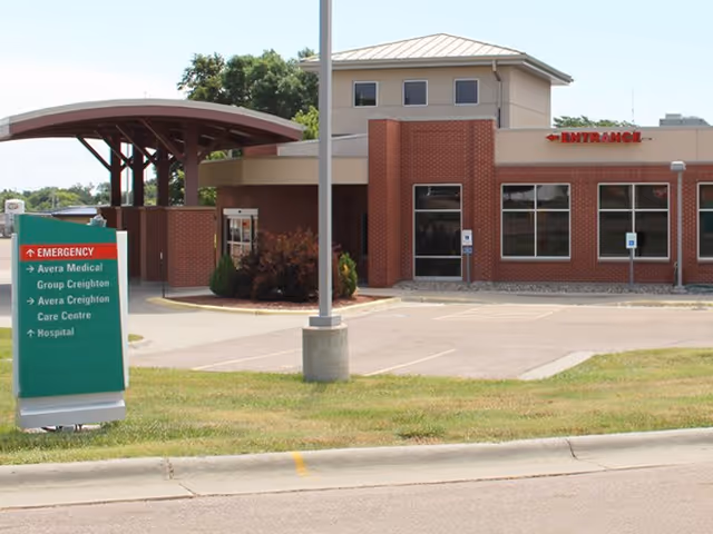Exterior view of Avera Creighton Clinic with brick entrance and emergency sign.