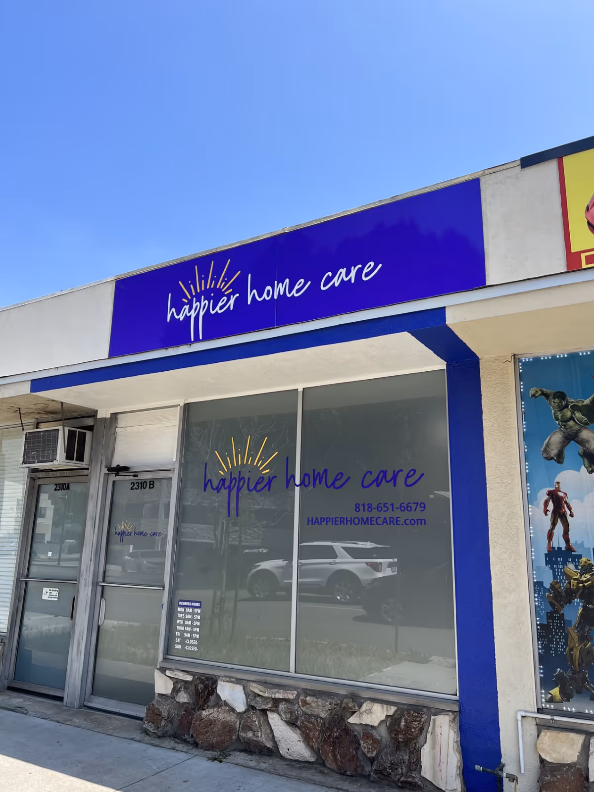 Exterior view of a building front featuring Happier Home Care signage.
