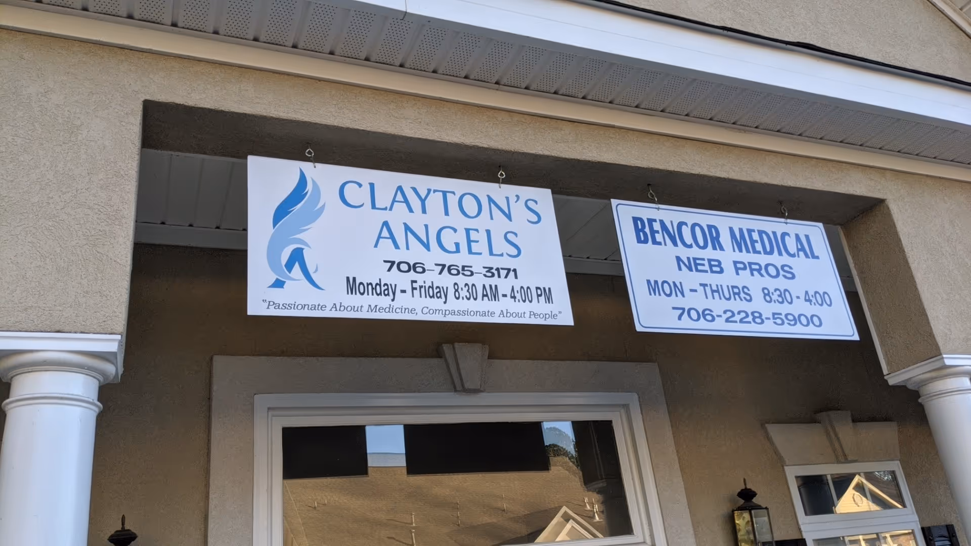 Exterior building front with two hanging signs for Clayton's Angels and BENCOR Medical NEB PROS.