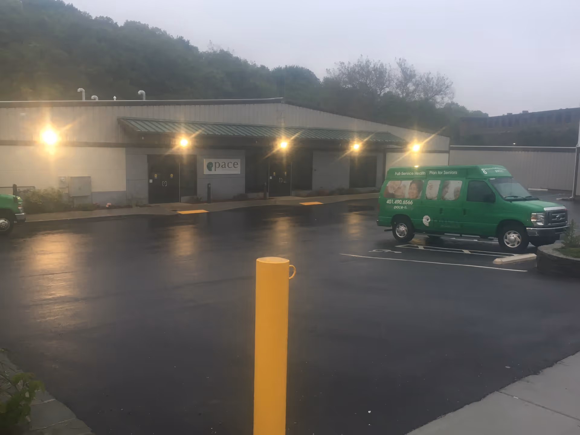 Exterior view of Pace Organization of RI building with green van in parking lot.