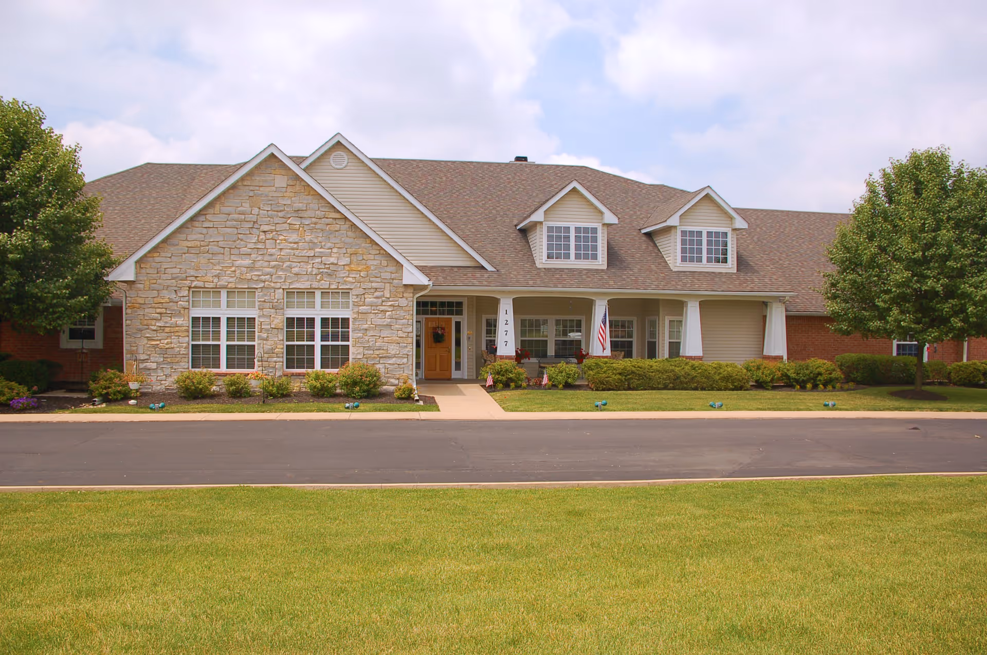 Exterior view of Brookdale Alliance senior living facility with stone facade and manicured lawn.