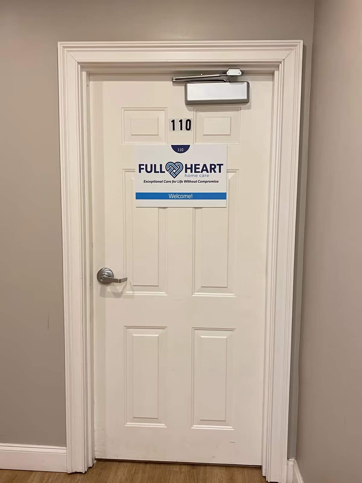 Interior door labeled 110 with a Full Heart Home Care welcome sign.