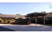 Front exterior of Corry Manor with a covered entrance and landscaped driveway.