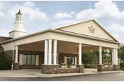 Front view of Kingston Care Center of Fort Wayne with a covered entry and columns.