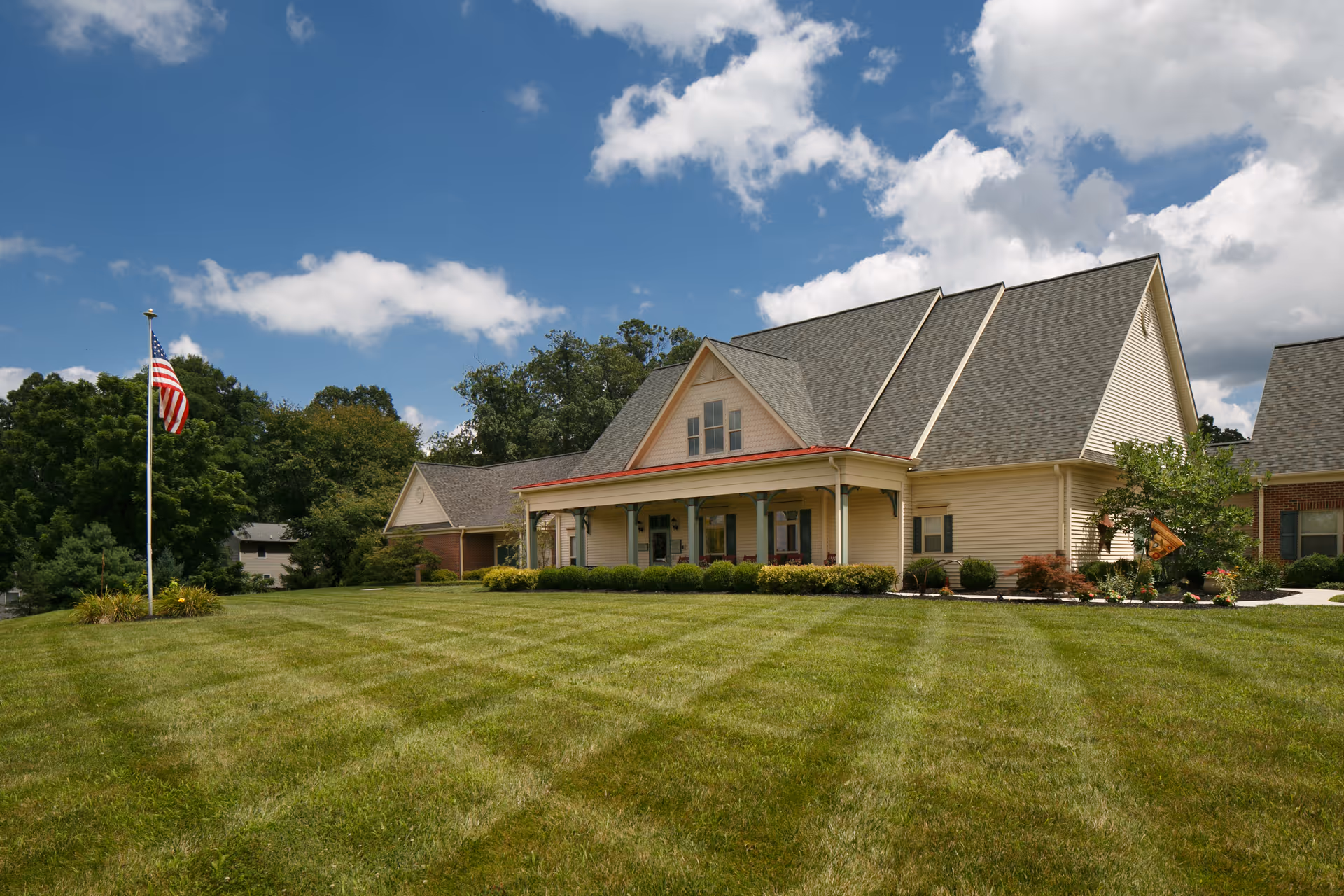Front view of Columbia Cottage of Hanover with manicured lawn and flagpole.