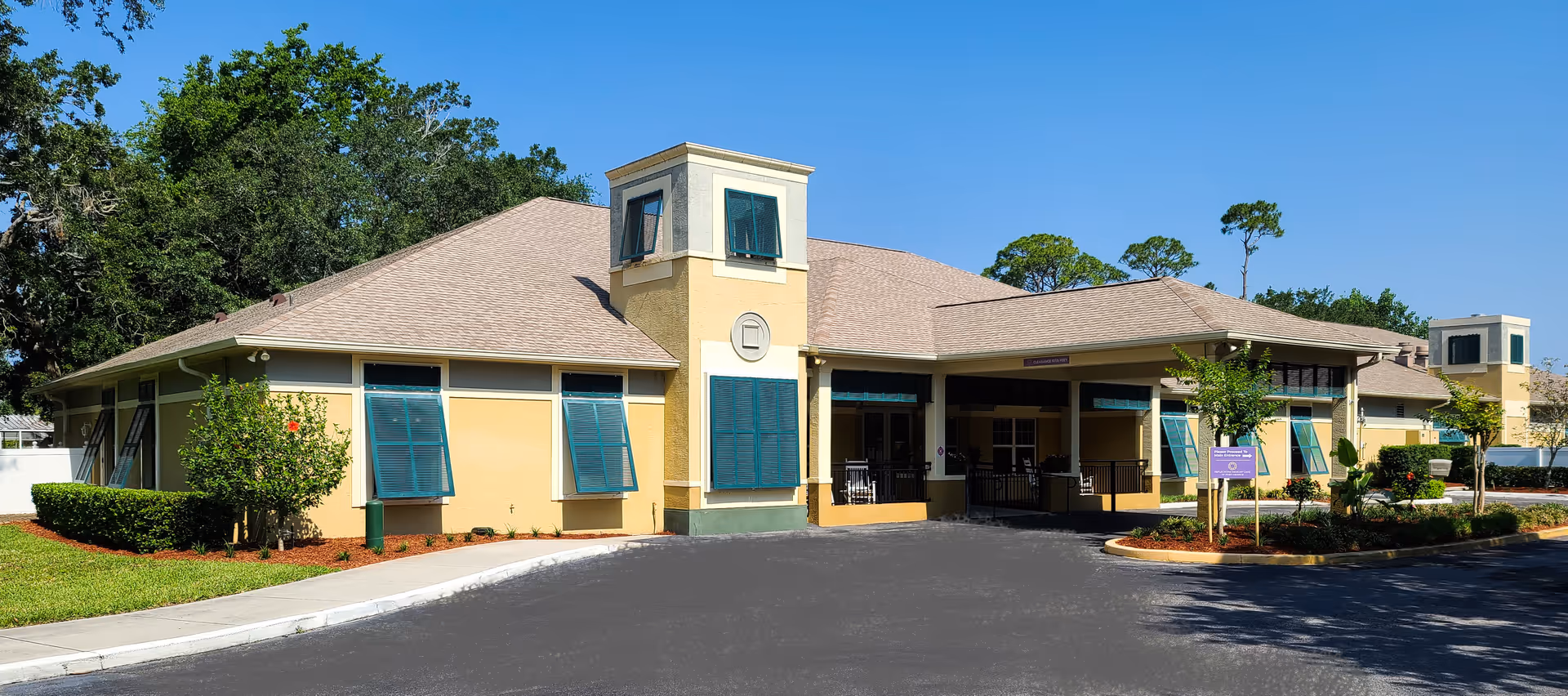 Front exterior view of Reflections Memory Care of Port Orange building with blue shutters.