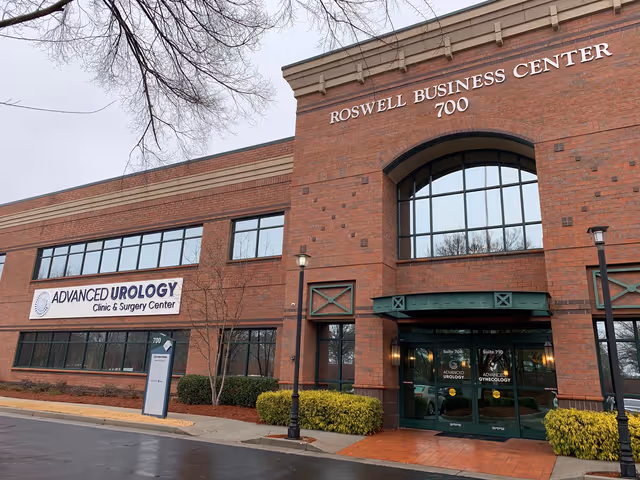 Exterior brick building with Advanced Urology Clinic signage and glass entrance.