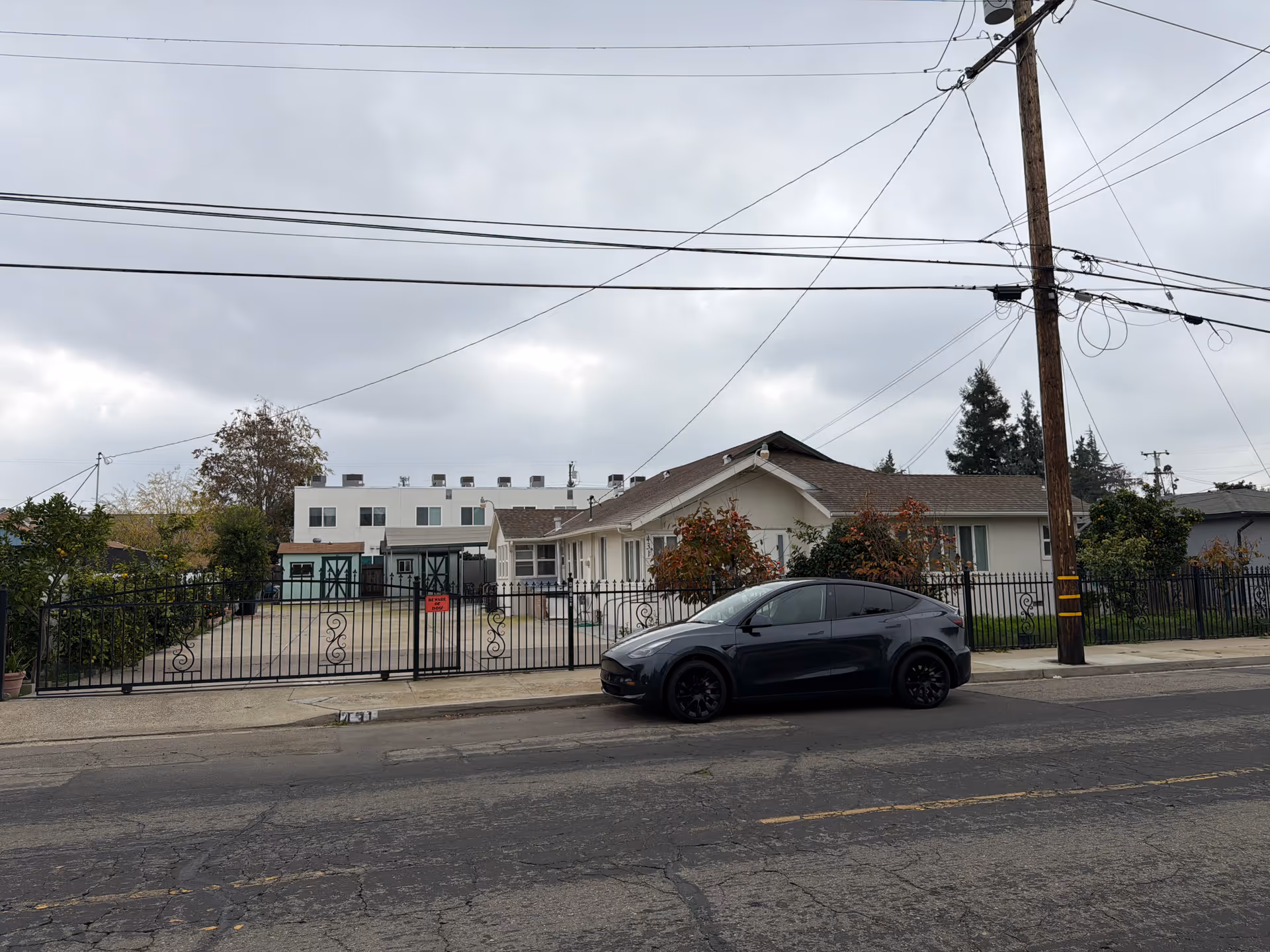Exterior view of Asara Senior Care facility with a gated entrance and parked car.