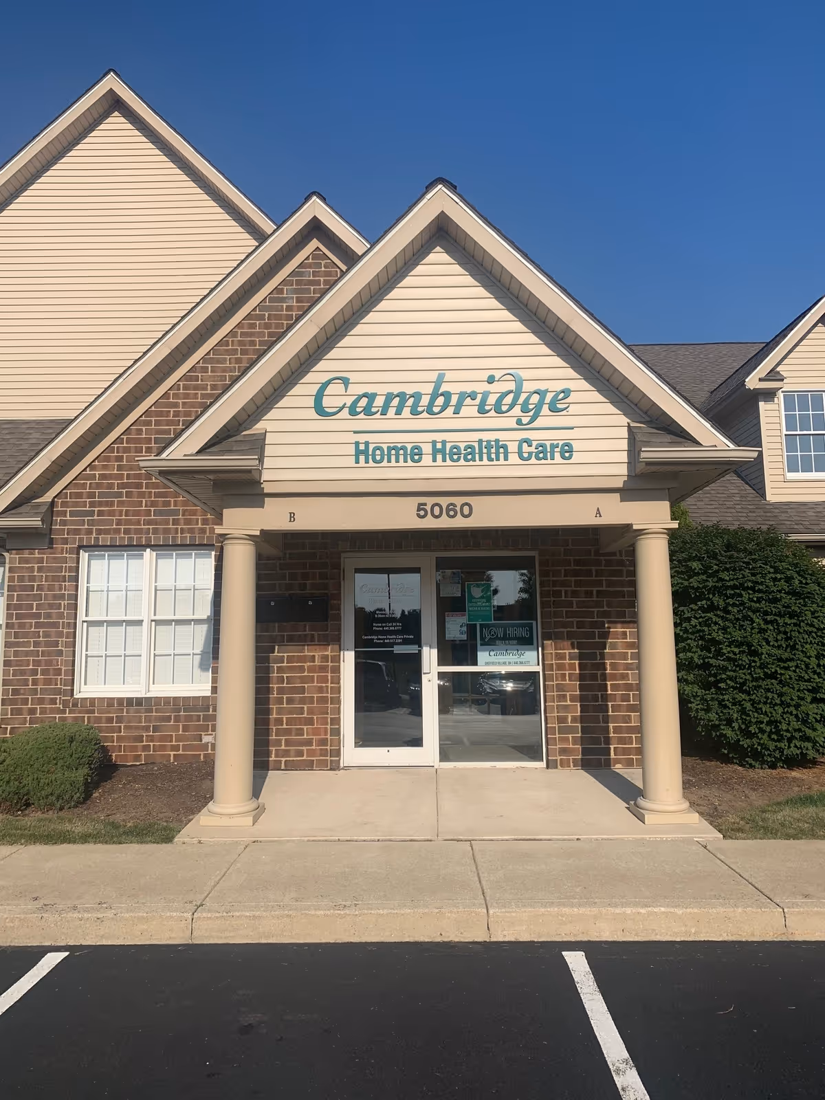 Front exterior of Cambridge Home Health Care building with entrance doors and columns.