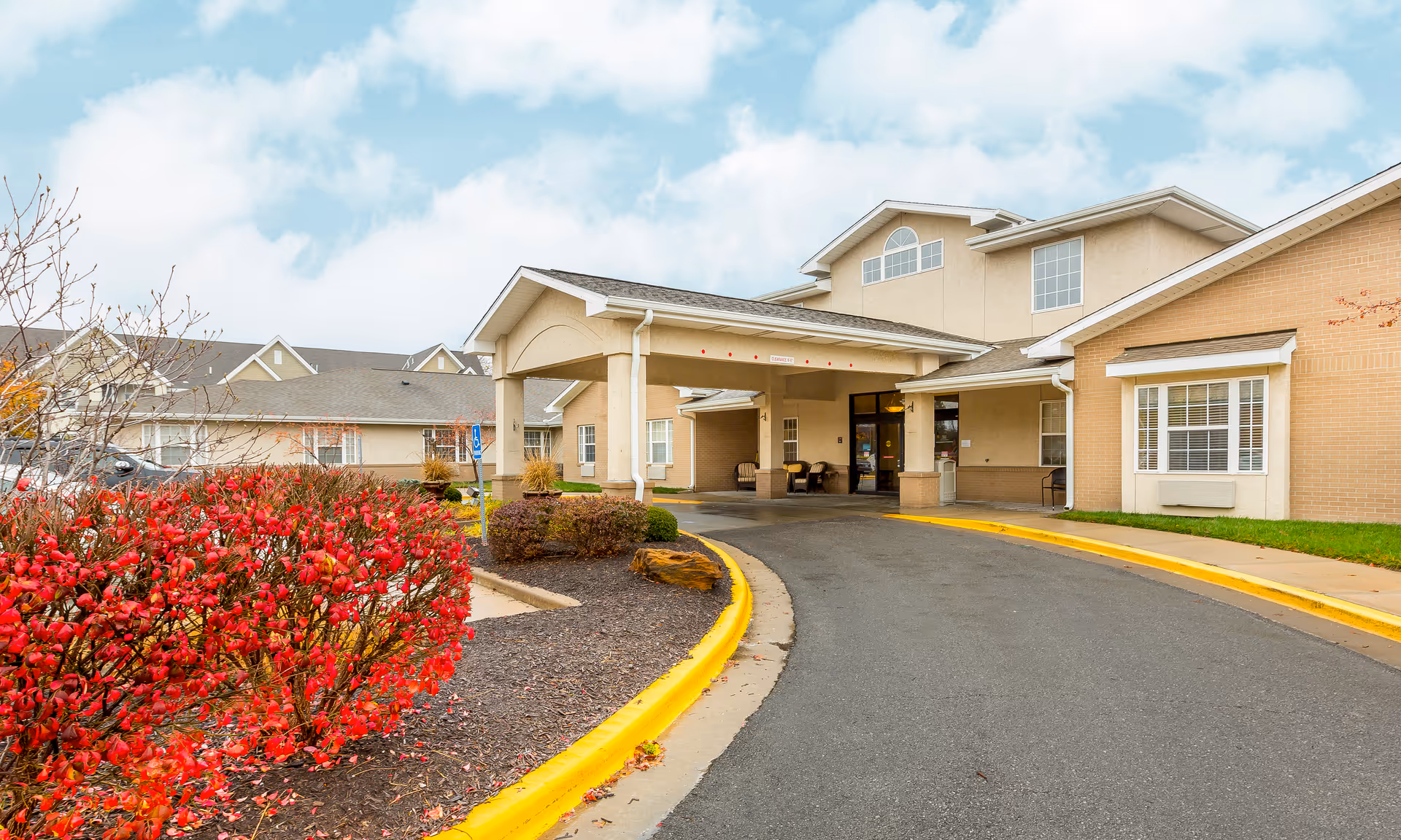 Front view of Brookdale Rosehill senior living center with entrance canopy and curved driveway.