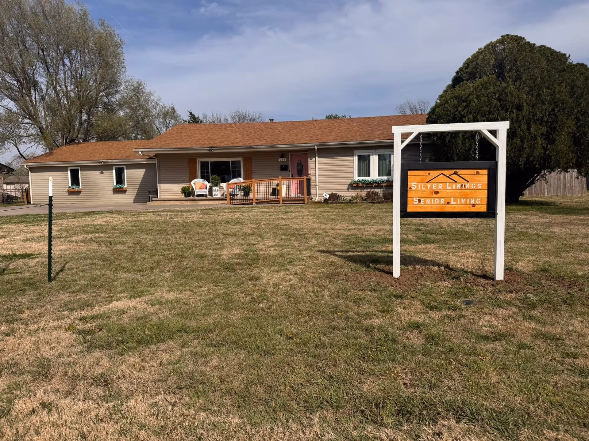 Front view of Silver Linings Senior Living building with porch and large sign.