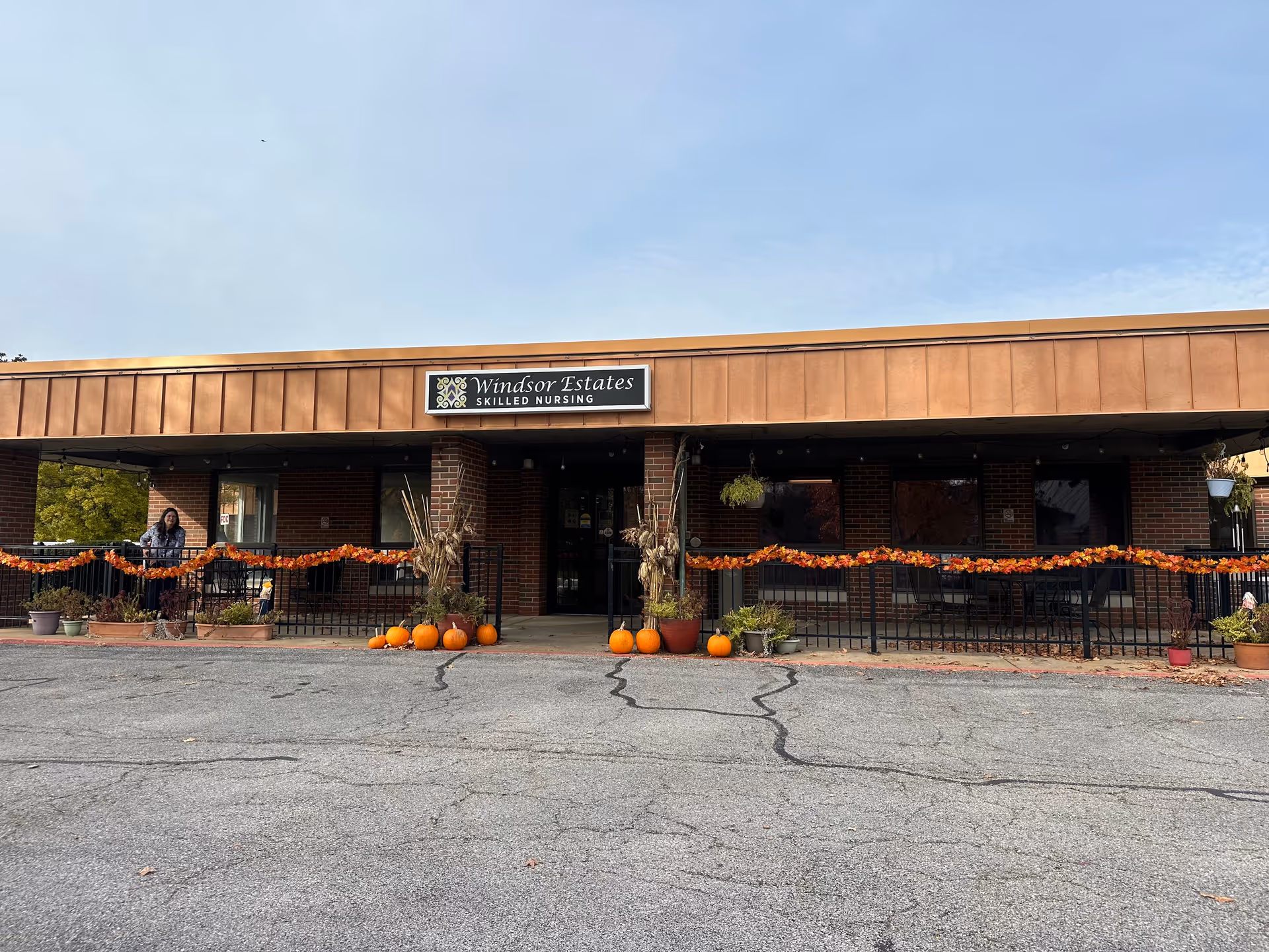Front entrance of Windsor Estates skilled nursing building decorated with pumpkins and fall garlands.