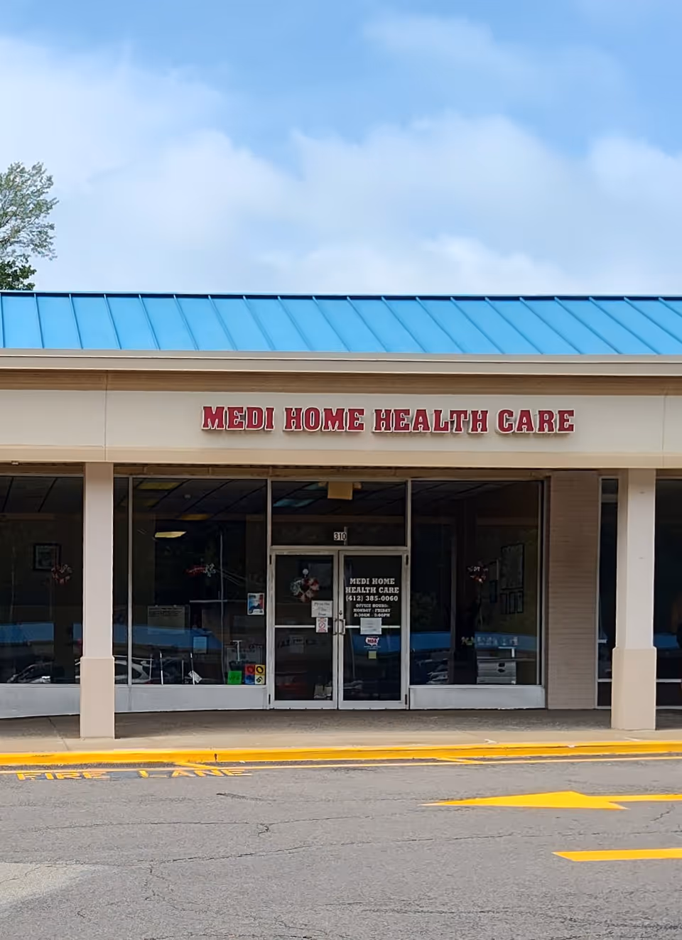 Front view of Medi Home Health Care building with glass doors and blue roof.