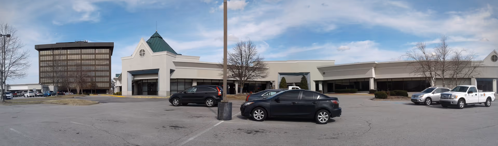 Exterior view of Abode Care Partners senior living building with a parking lot.