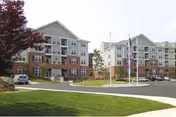 Exterior view of Residences at Highland Glen, a multi-story senior living building.