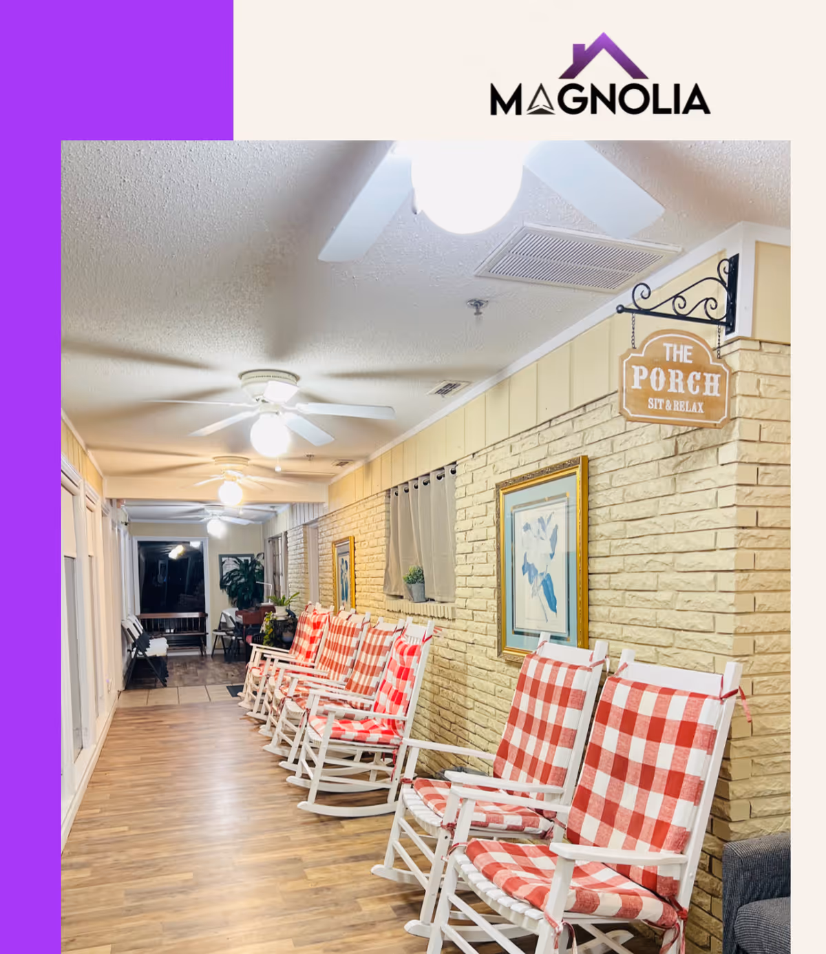 Indoor corridor with brick wall, lined with red-checked rocking chairs and ceiling fans.