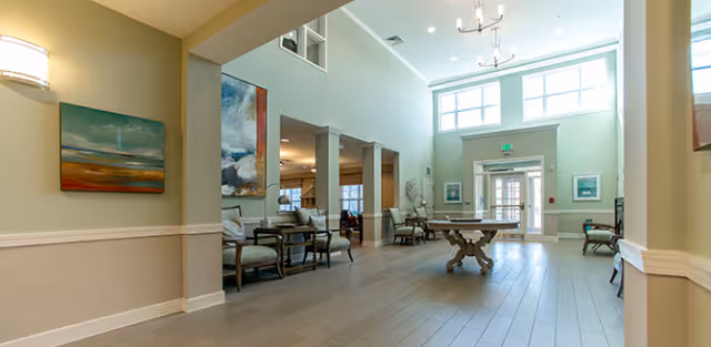 Lobby of Villalge Park Adult Residential Care Home with seating and art.