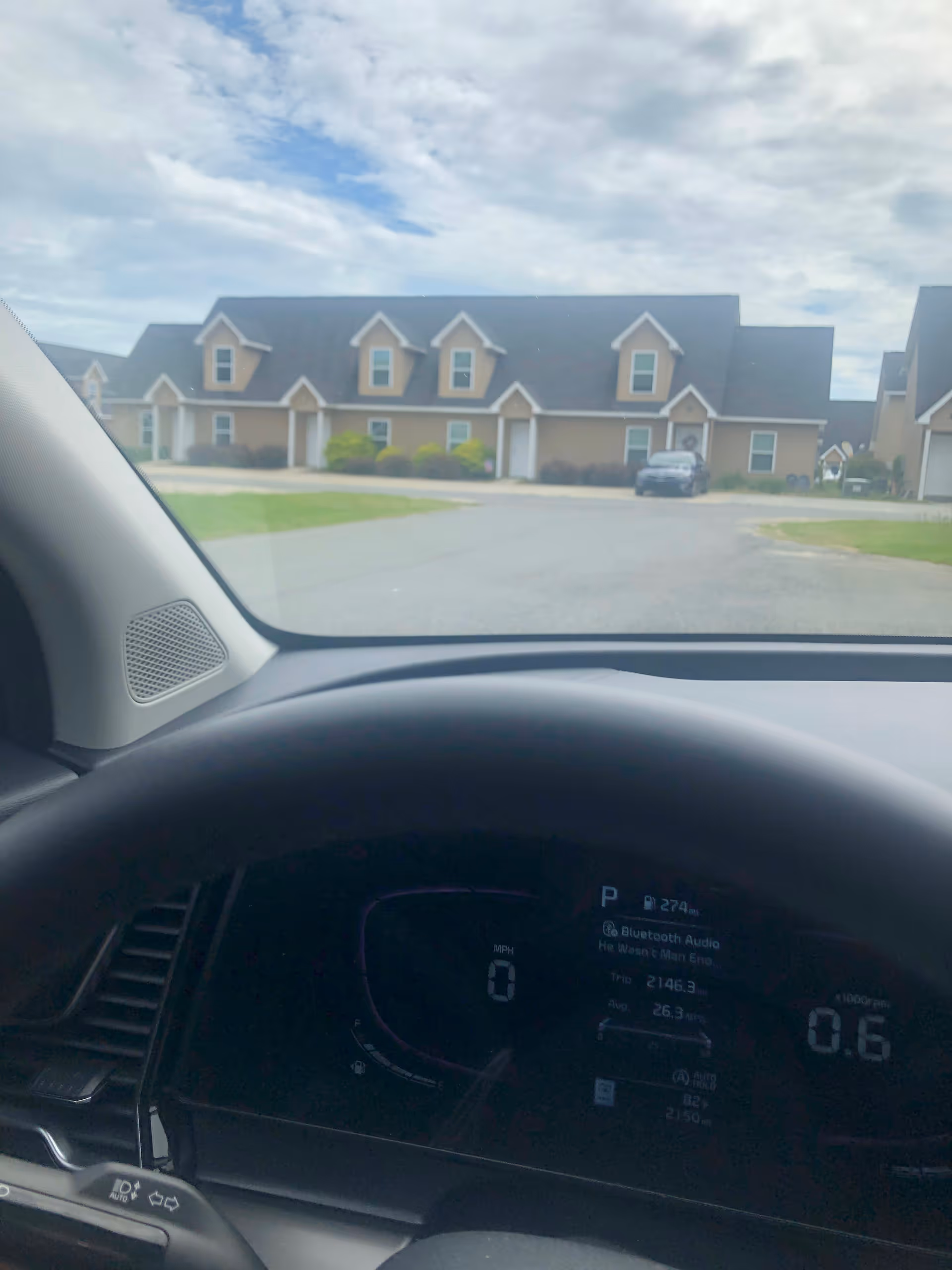 Front view of a senior living facility with attached townhome-style units, seen from a car.