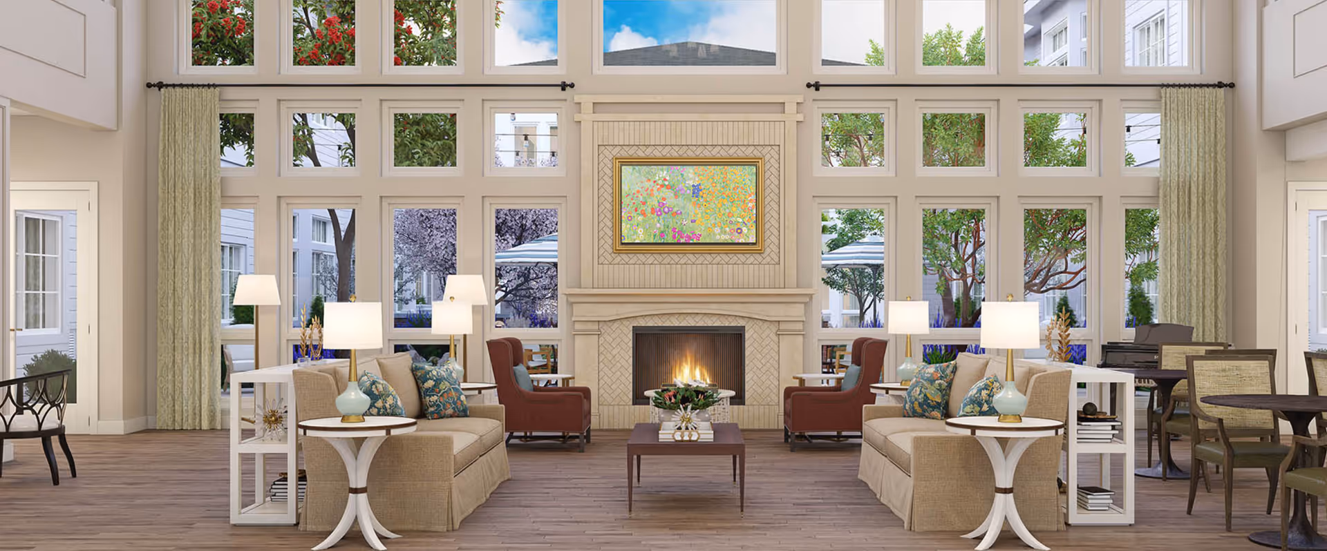 Bright common lounge with sofas, armchairs, side tables, a central fireplace and tall windows overlooking trees.