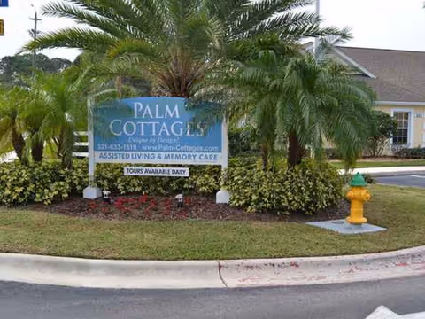 Exterior view of Palm Cottages of Rockledge entrance sign surrounded by palm trees.