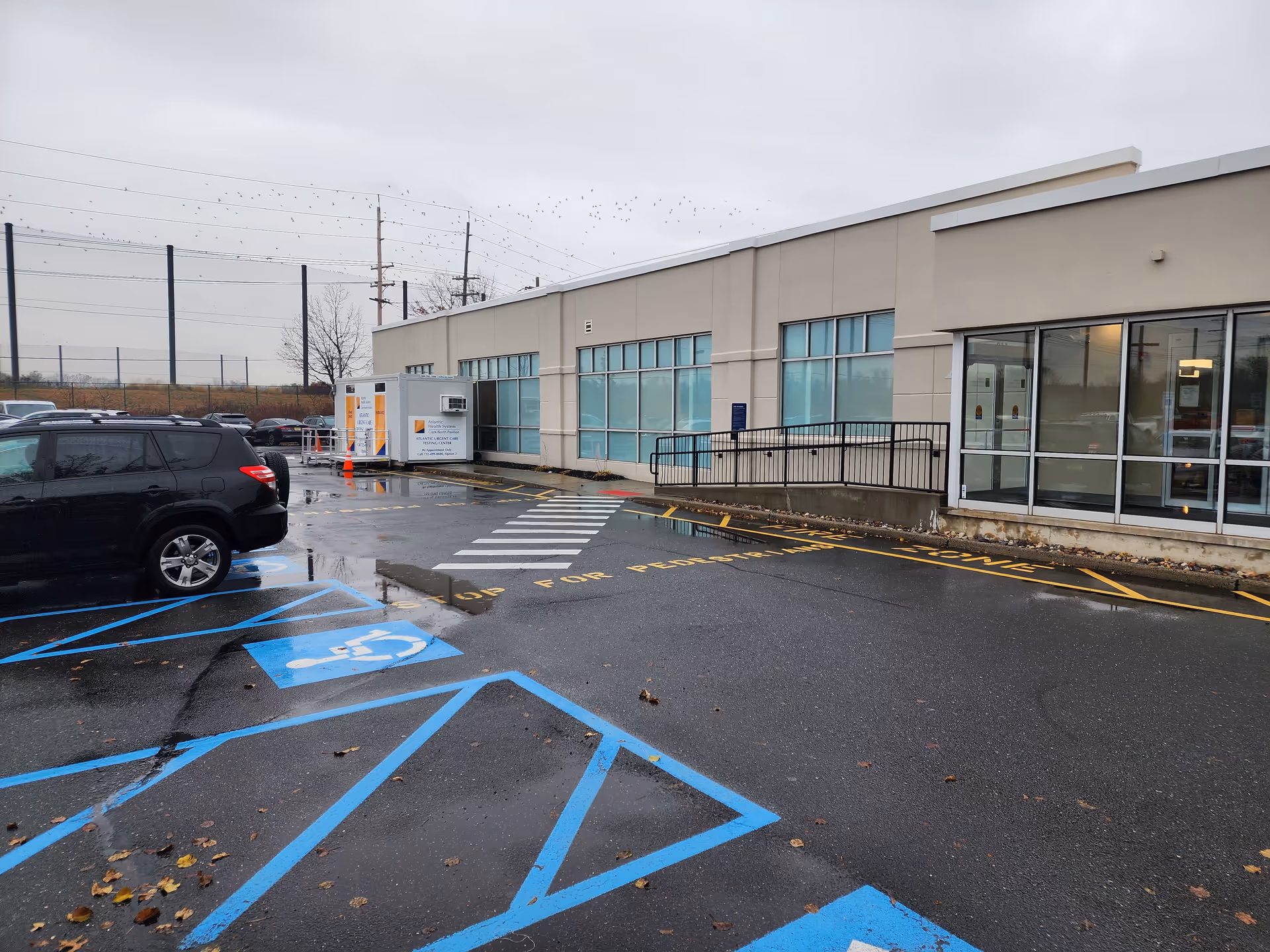 Exterior view of Atlantic Health System Clark - North Pavilion with glass entrance and parking.