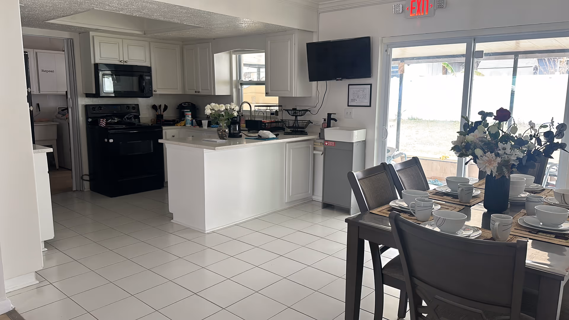 Bright kitchen and dining area with a table set for a meal.