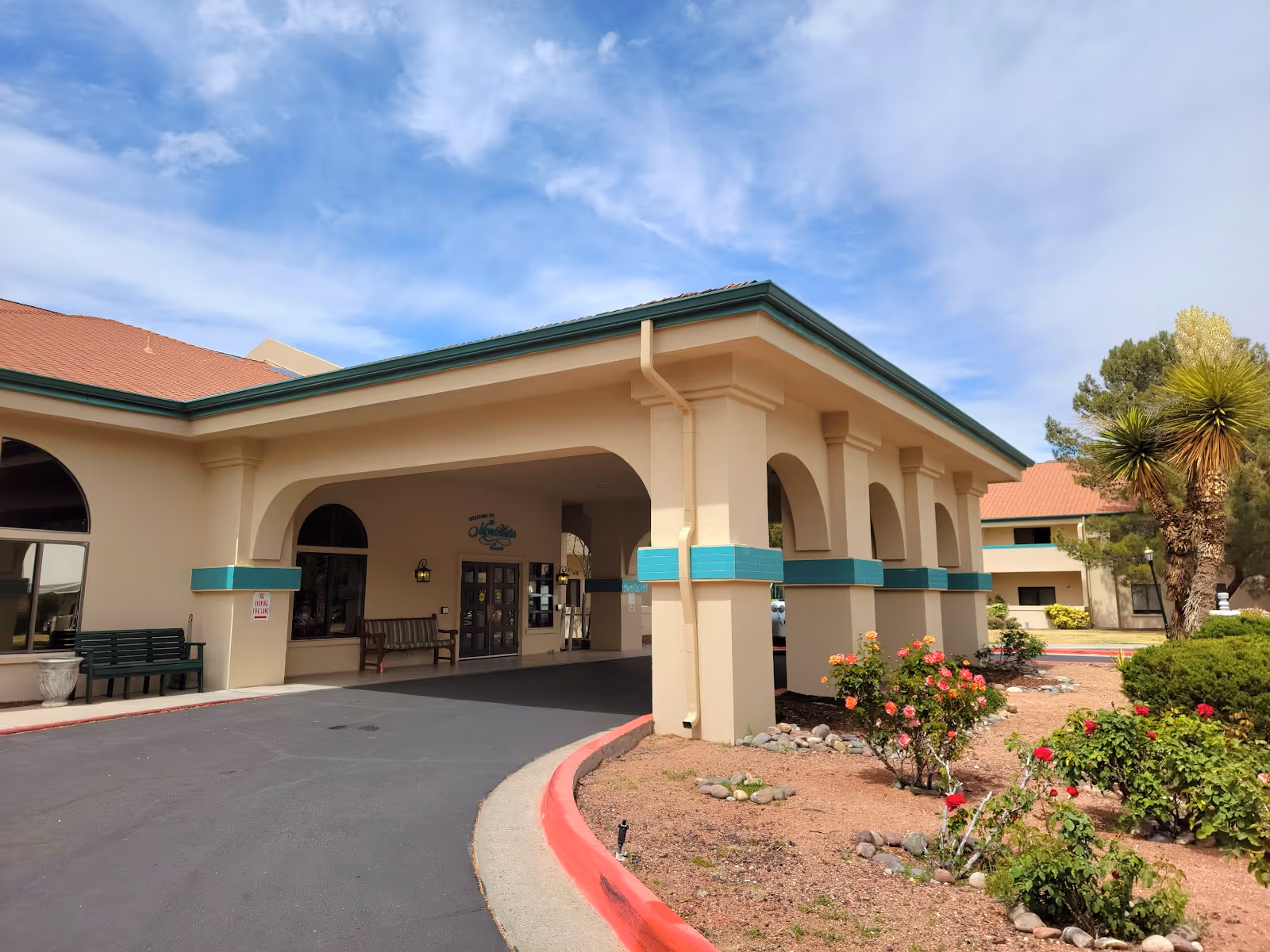 Exterior view of The MonteVista at Coronado entrance with arches and landscaped front.