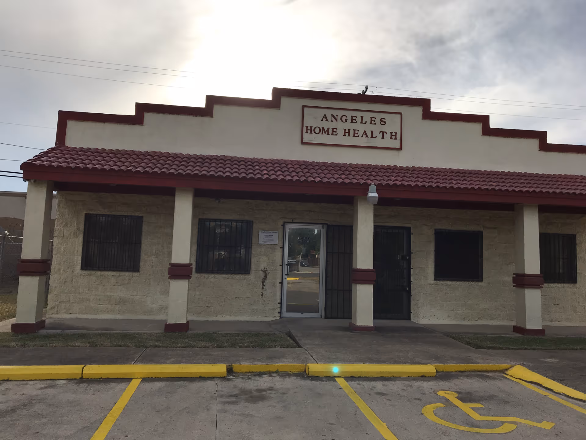 Front exterior of Angeles Home Health facility with parking and entrance