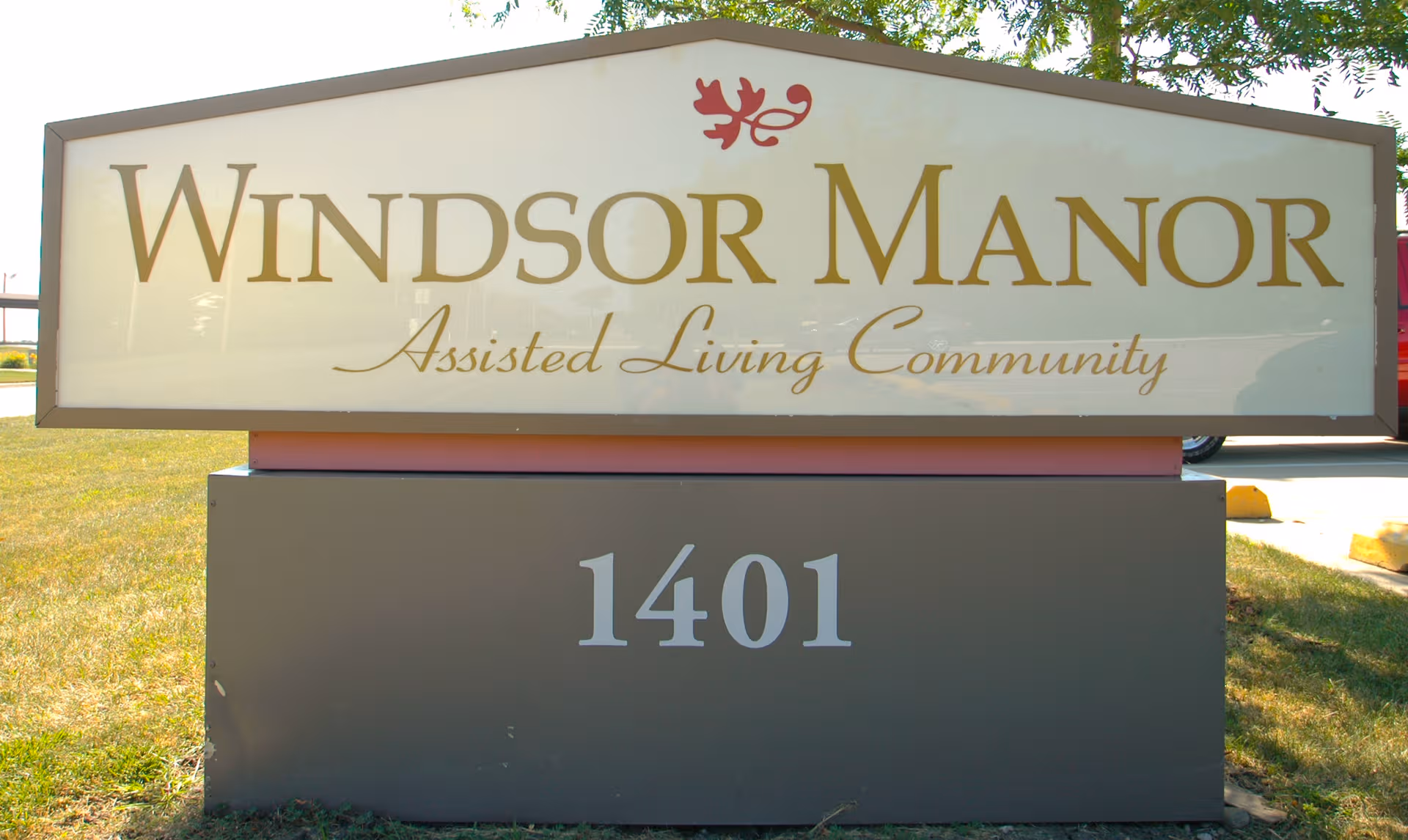 Exterior sign reads Windsor Manor Assisted Living Community with the number 1401.