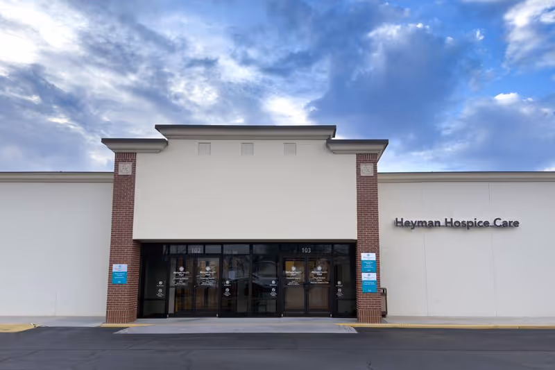 Front view of Heyman Hospice Care entrance with glass doors.