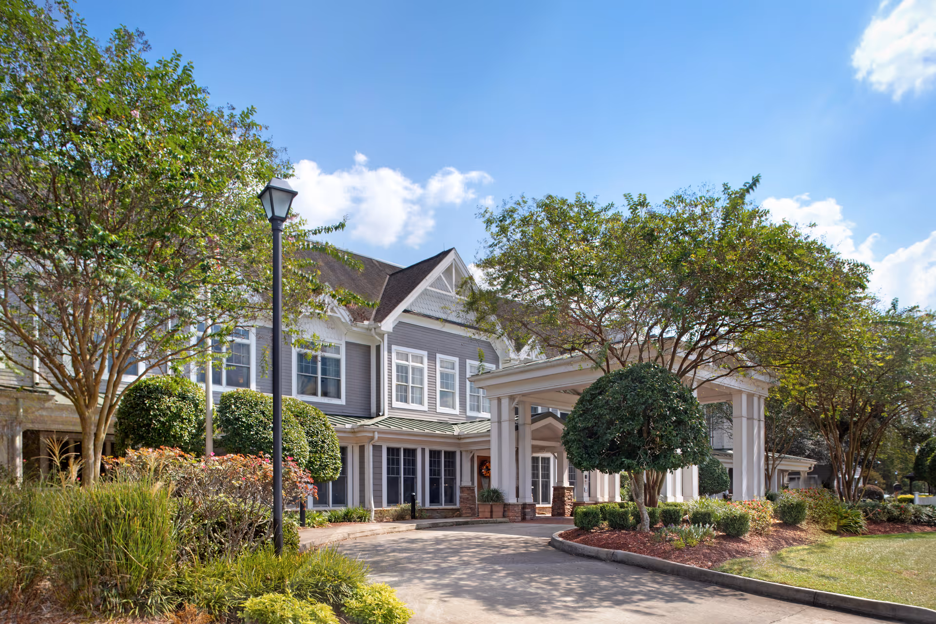 Sunrise at Siegen exterior showing the front entrance and landscaped grounds