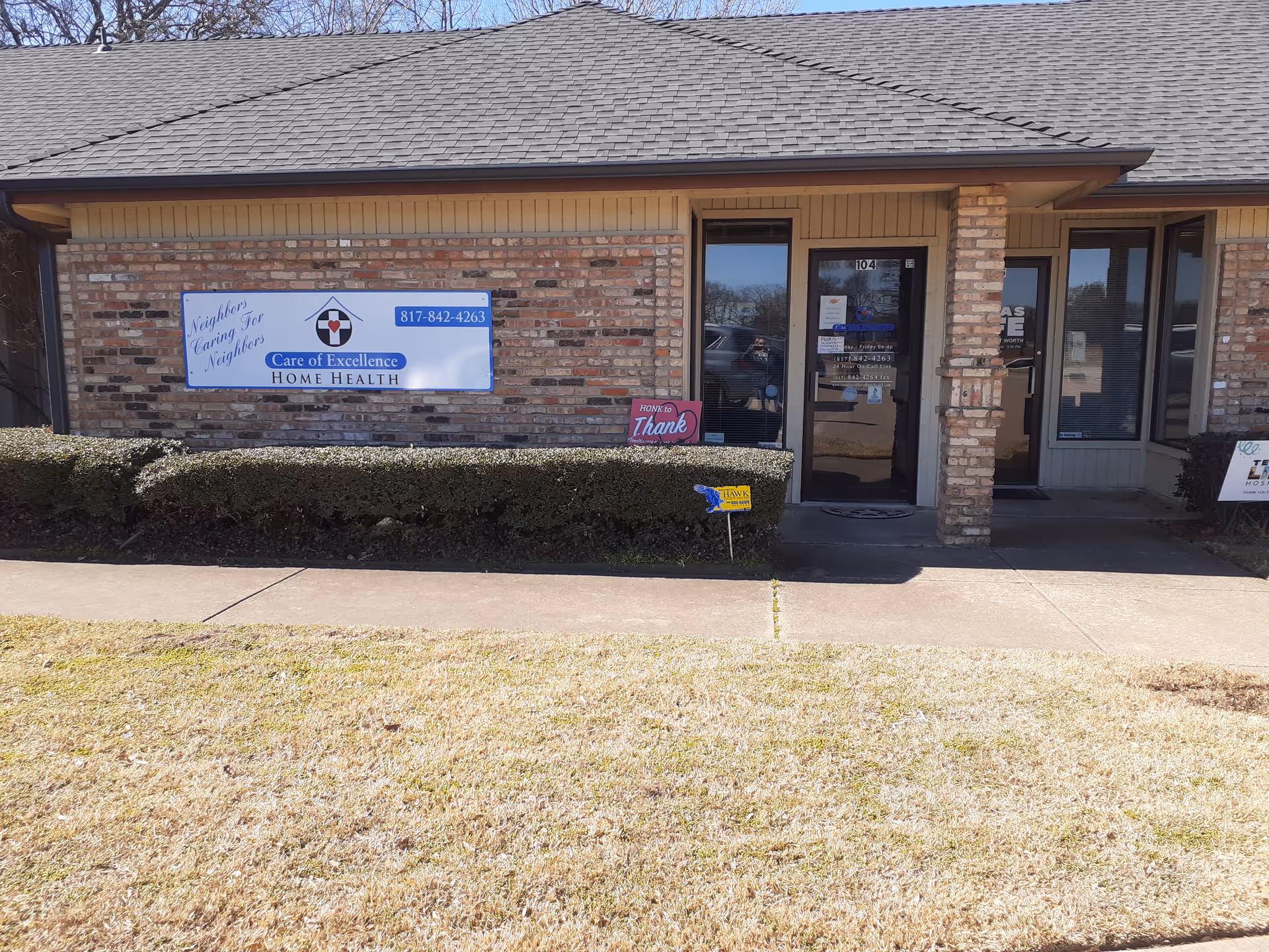 Front view of Care of Excellence Home Health facility with sign and entrance