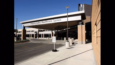Exterior view of Prairie Lakes Healthcare System entrance with a covered drop-off.