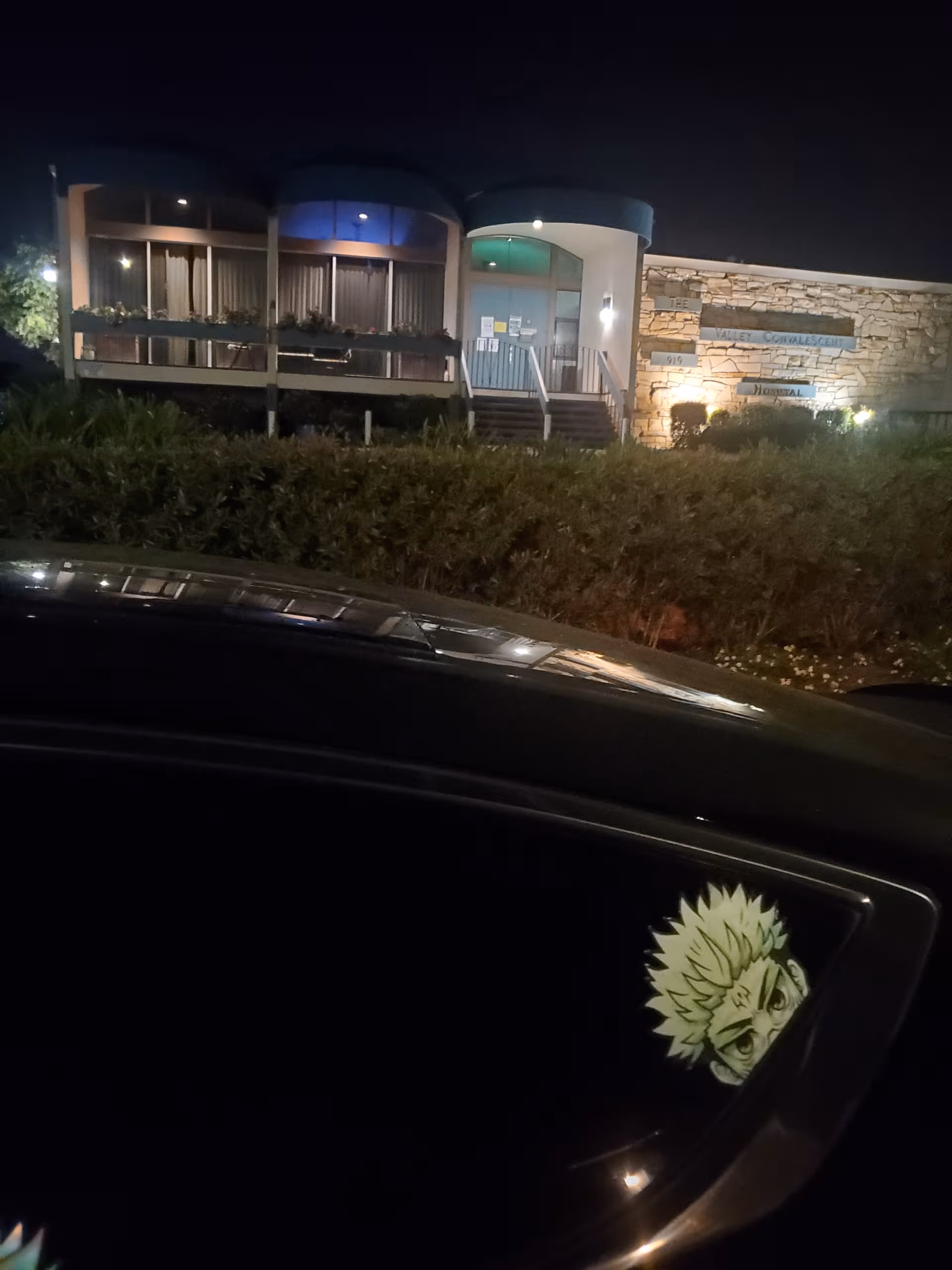 Night view of the Manresa Healthcare Center front entrance with stairs and signage.