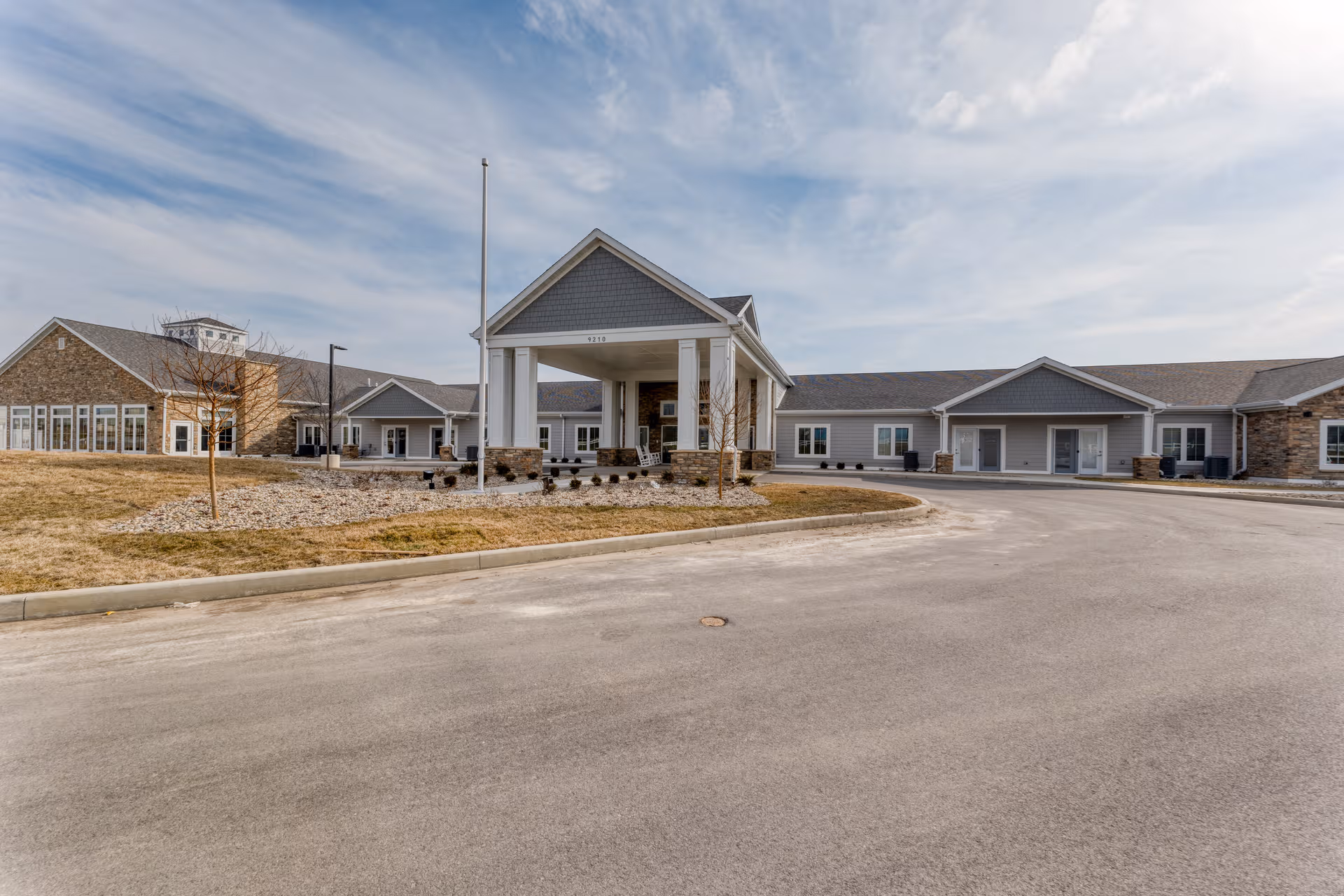 Exterior view of Cedarhurst Senior Living facility with a covered entrance and circular driveway.