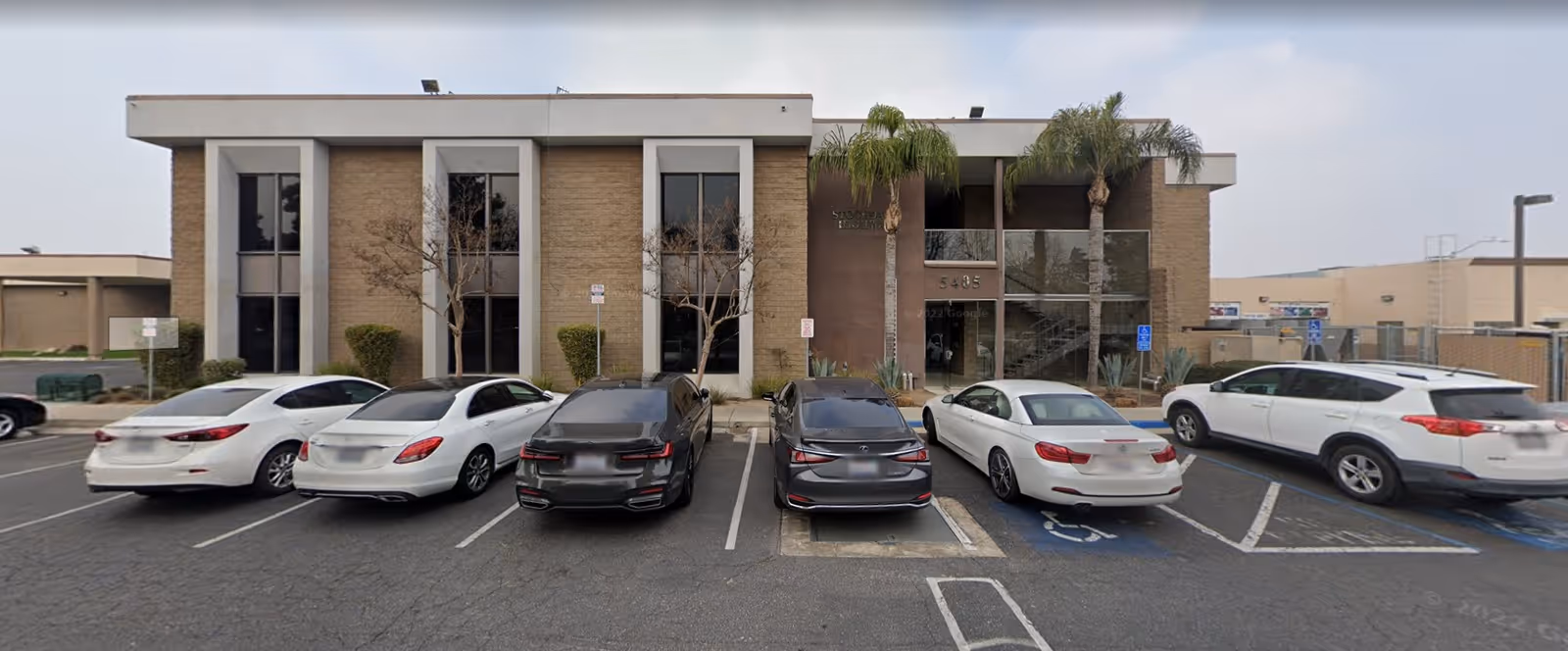 Front view of Senior Helpers of Bakersfield, CA facility with parked cars in front.