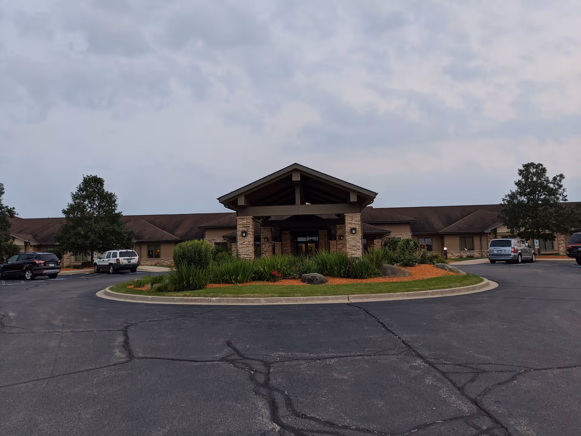 Exterior view of NorthPointe Terrace with circular driveway and landscaped entrance.