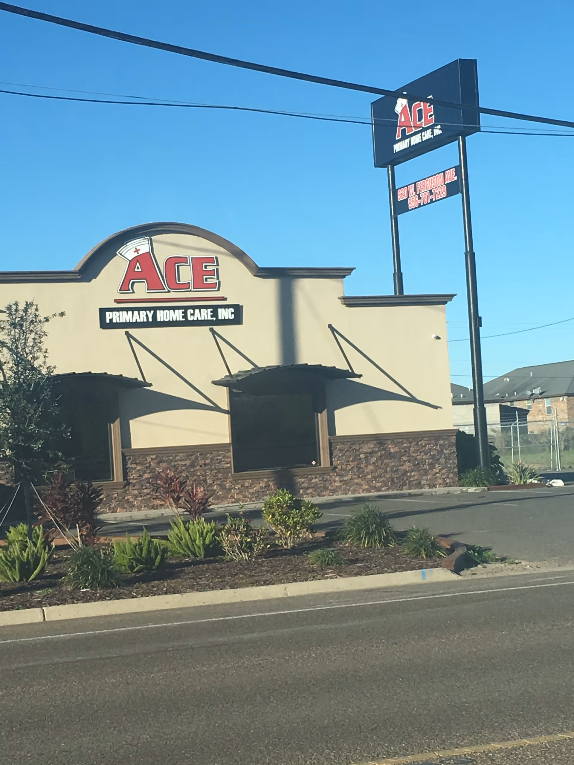 Exterior view of Ace Primary Home Care, Inc. building with large sign and landscaping.