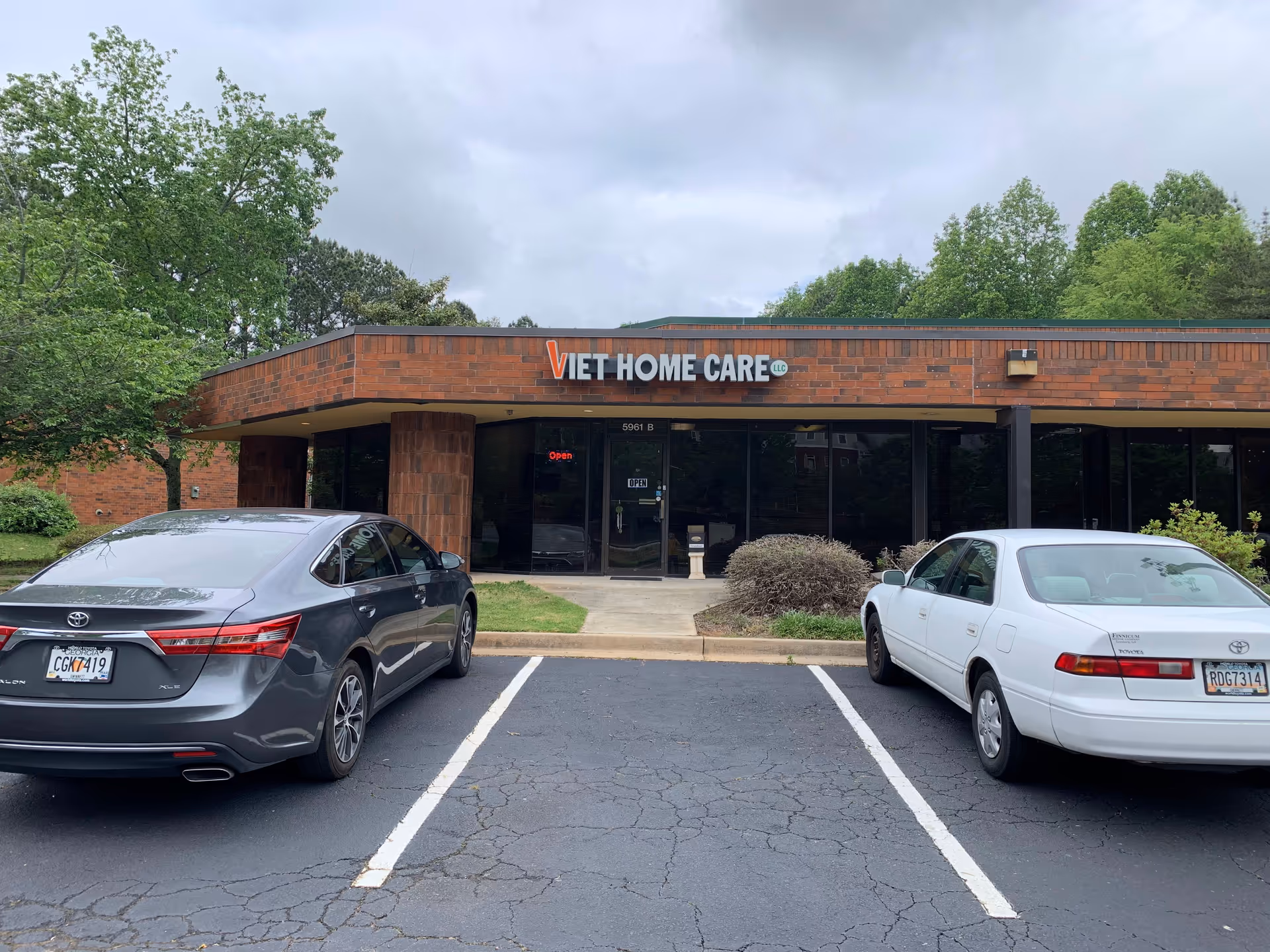 Front view of Viet Home Care LLC building with parked cars in the lot