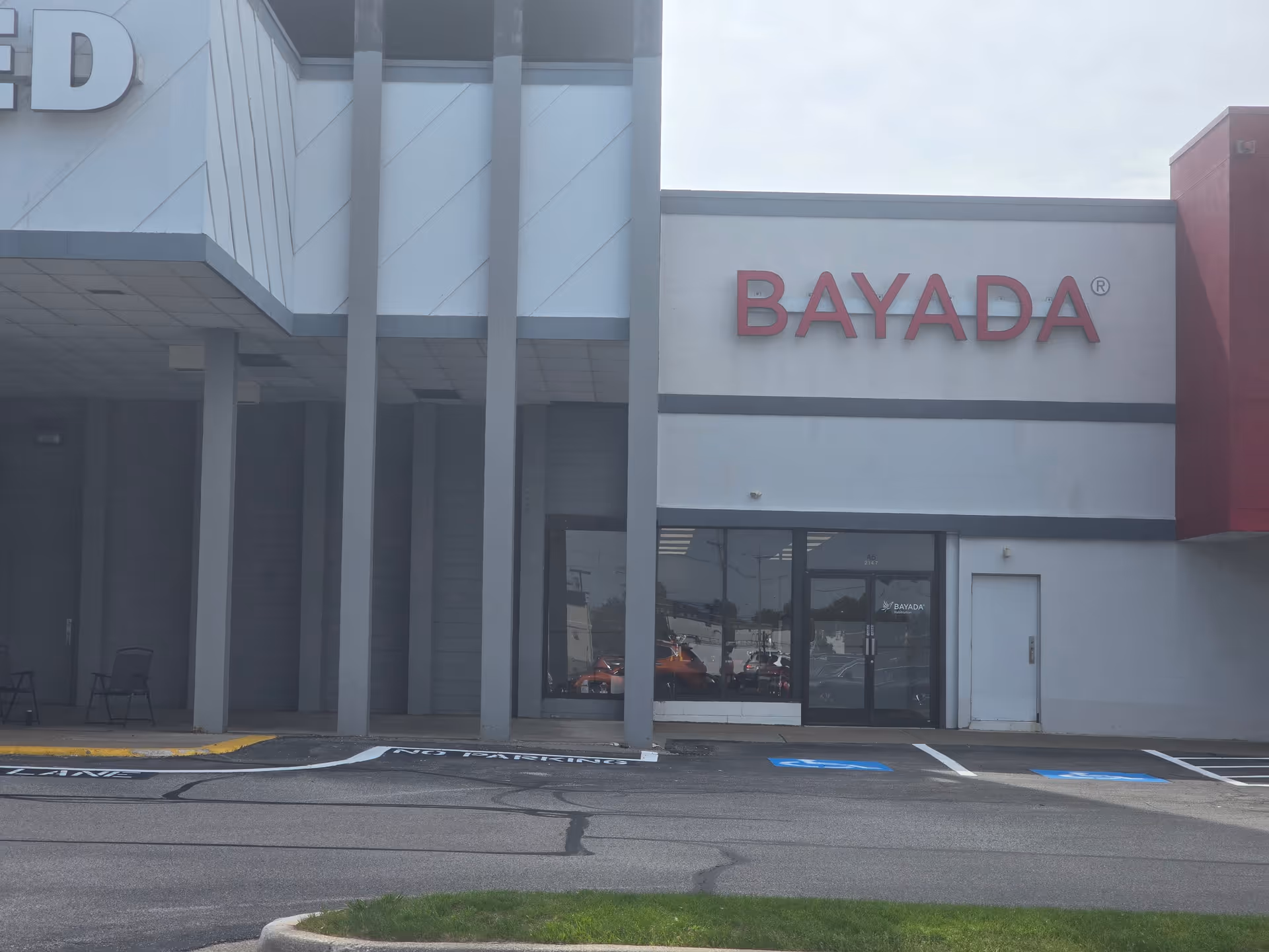 Front exterior of a BAYADA Habilitation building with a large BAYADA sign.