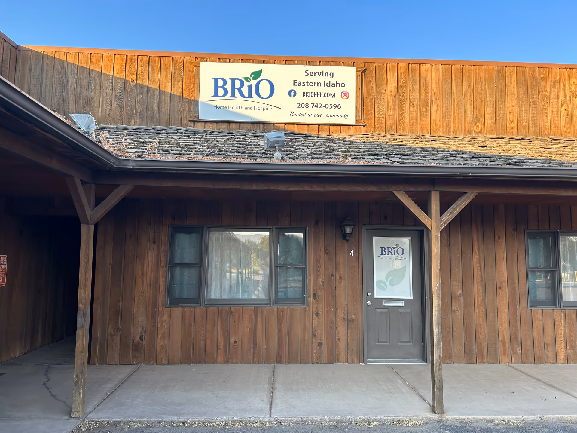 Wood-paneled building front with BRiO Home Health and Hospice sign and entrance.