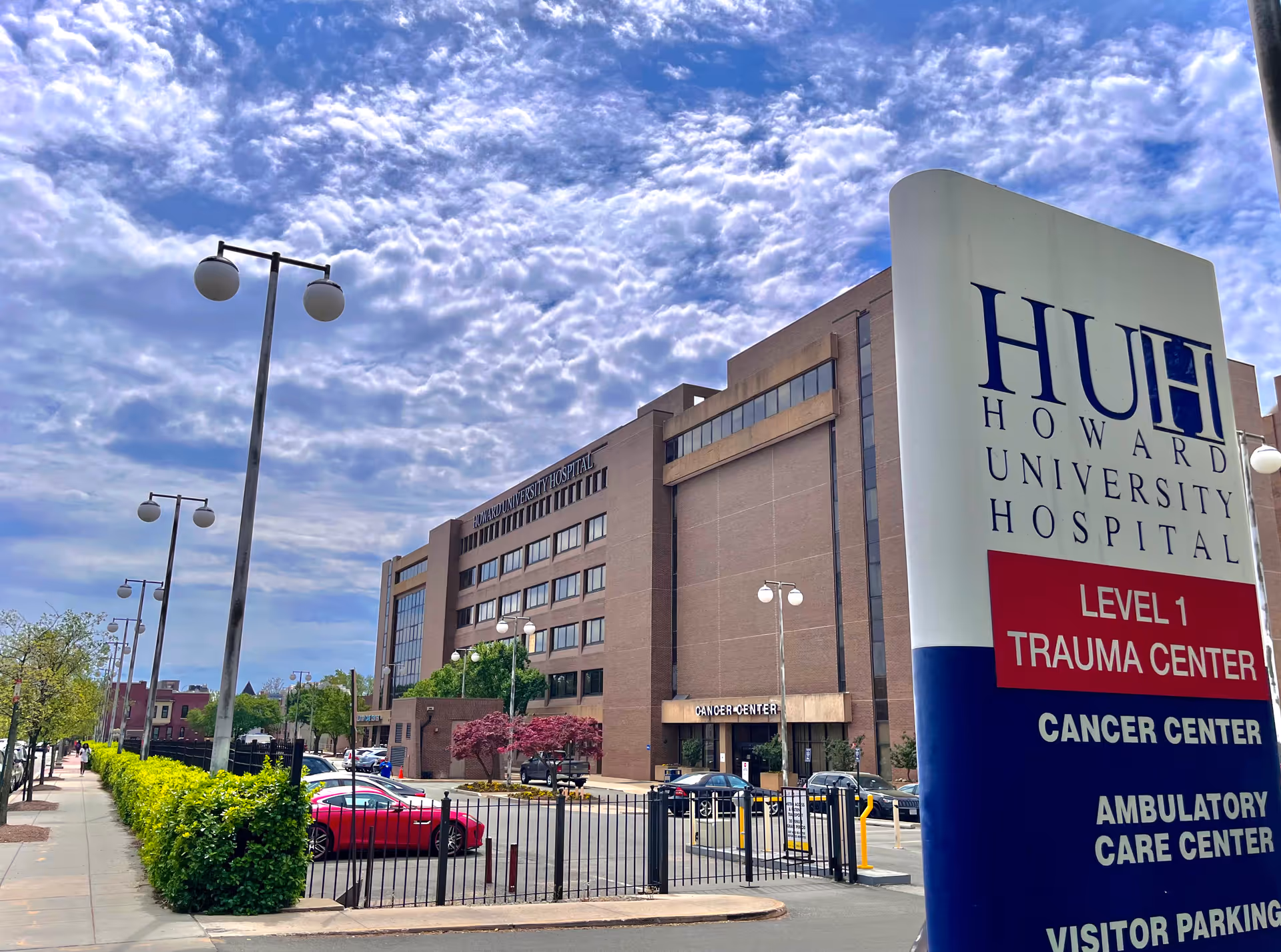 Exterior view of Howard University Hospital with a large sign and blue sky.